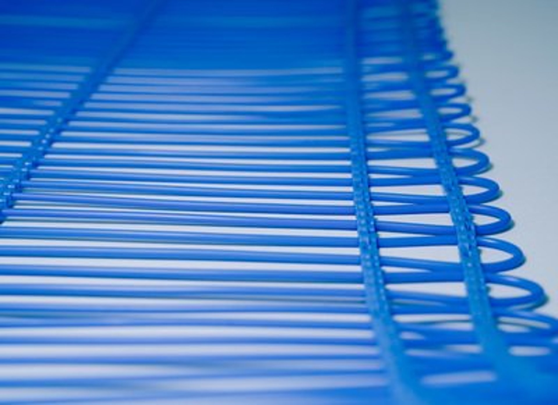 an abstract photo of a curved building with a blue sky in the background