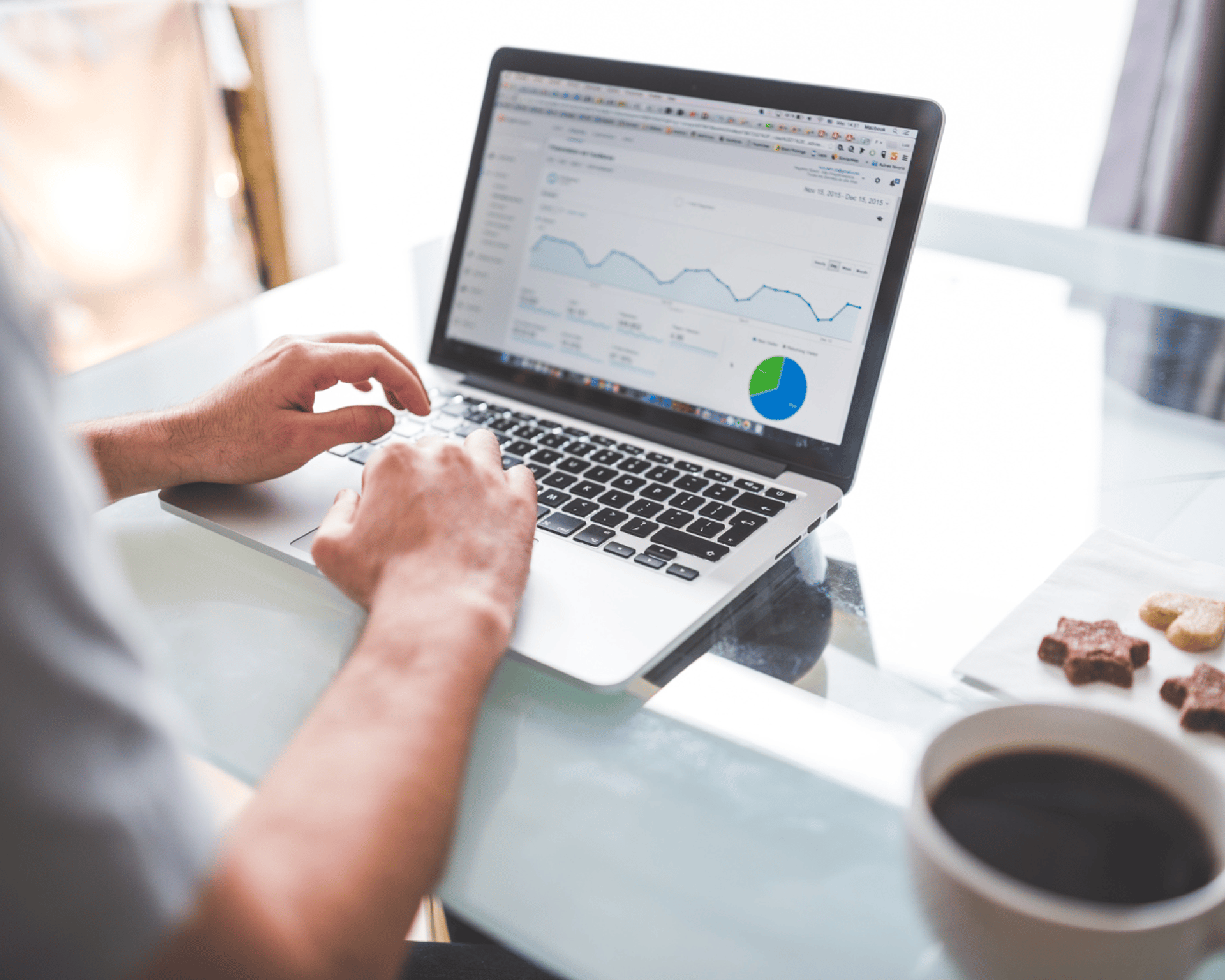 Man at desk with laptop, running campaigns and analyzing results