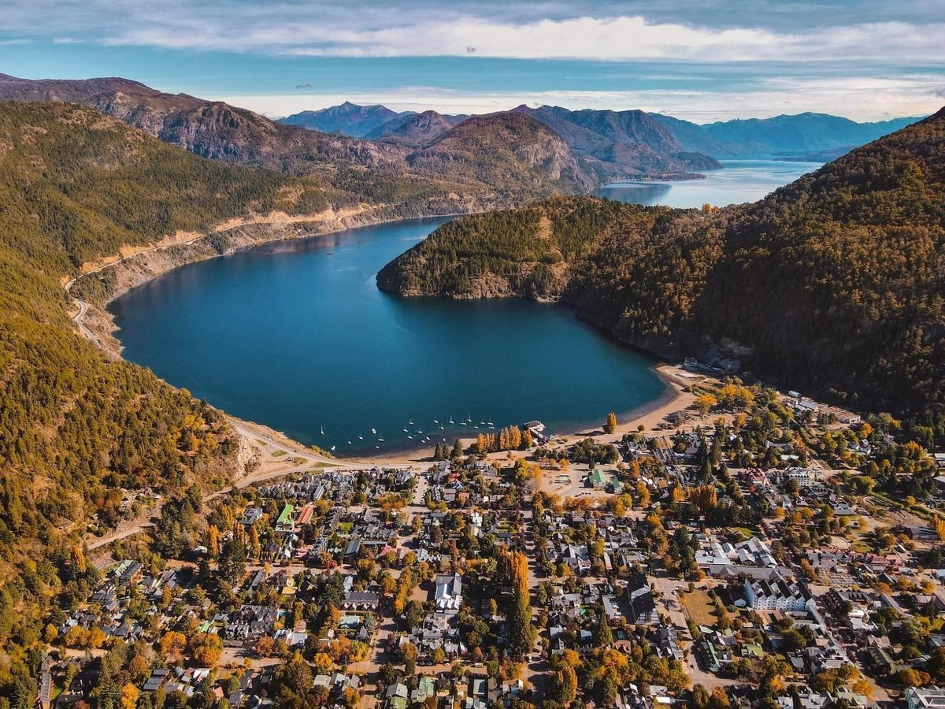 a scenic view of a lake surrounded by mountains