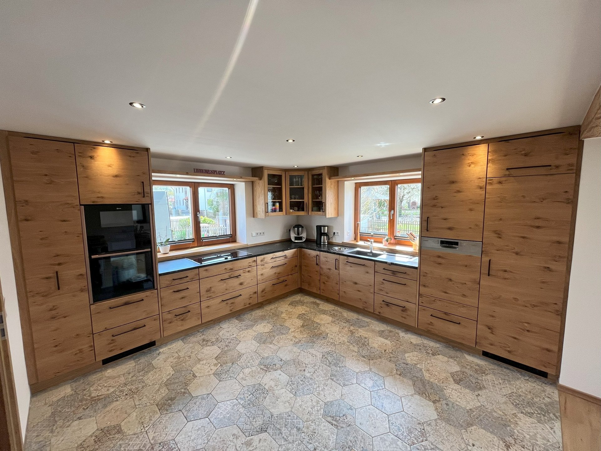 aerial shot of road surrounded by green trees