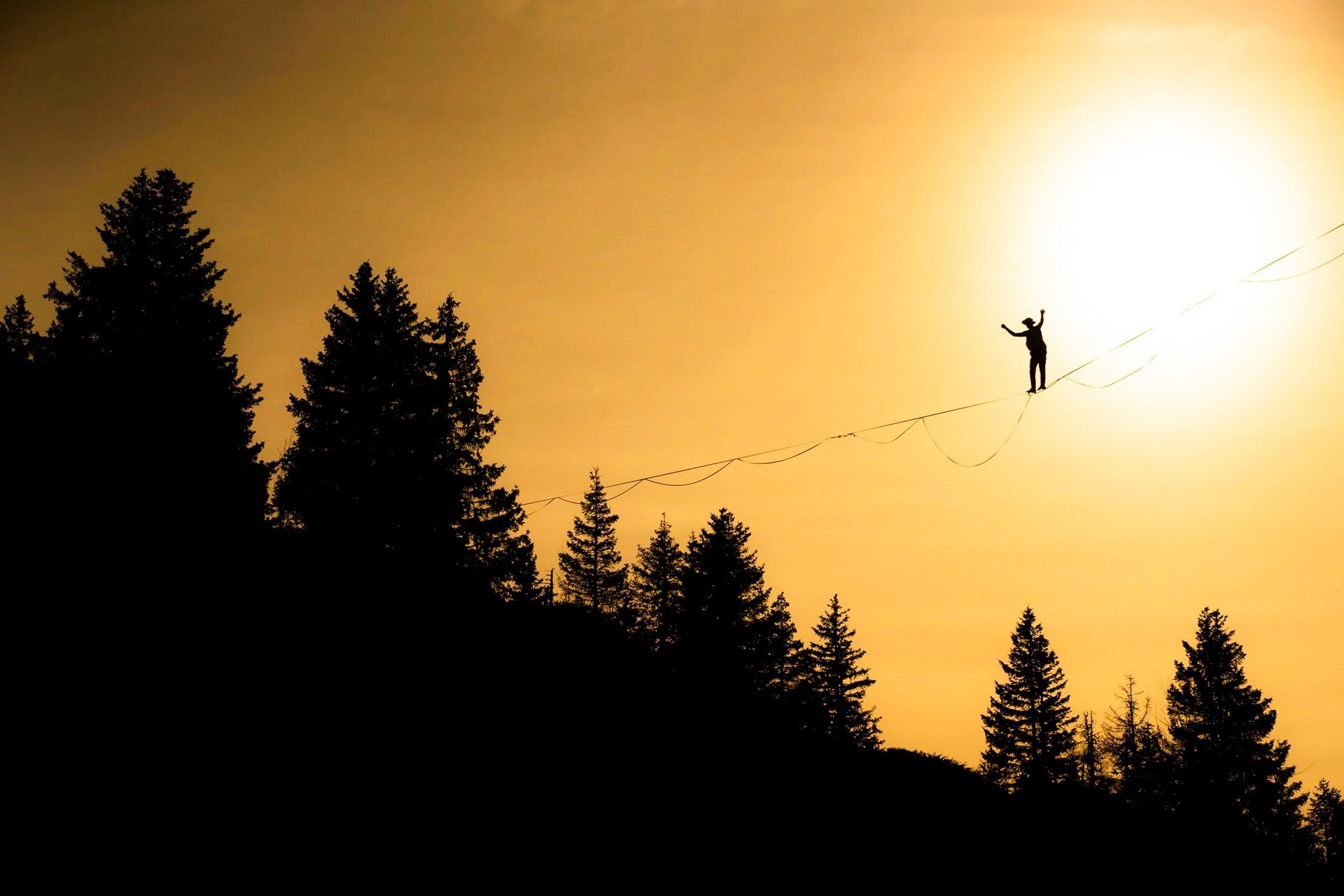 woman crossing the shore by balancing on the rope
