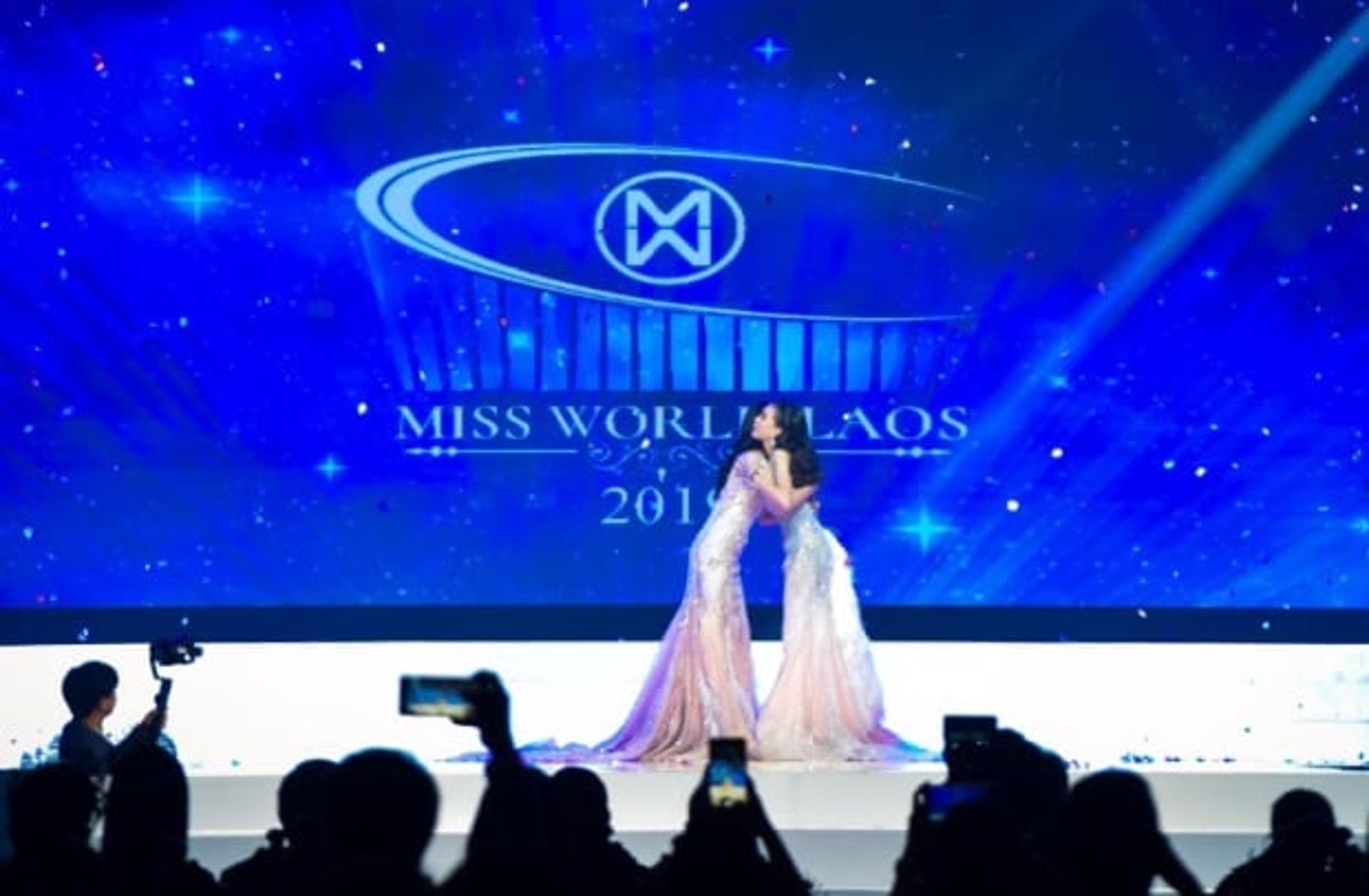 a cup of coffee next to a sign that says event sponsor