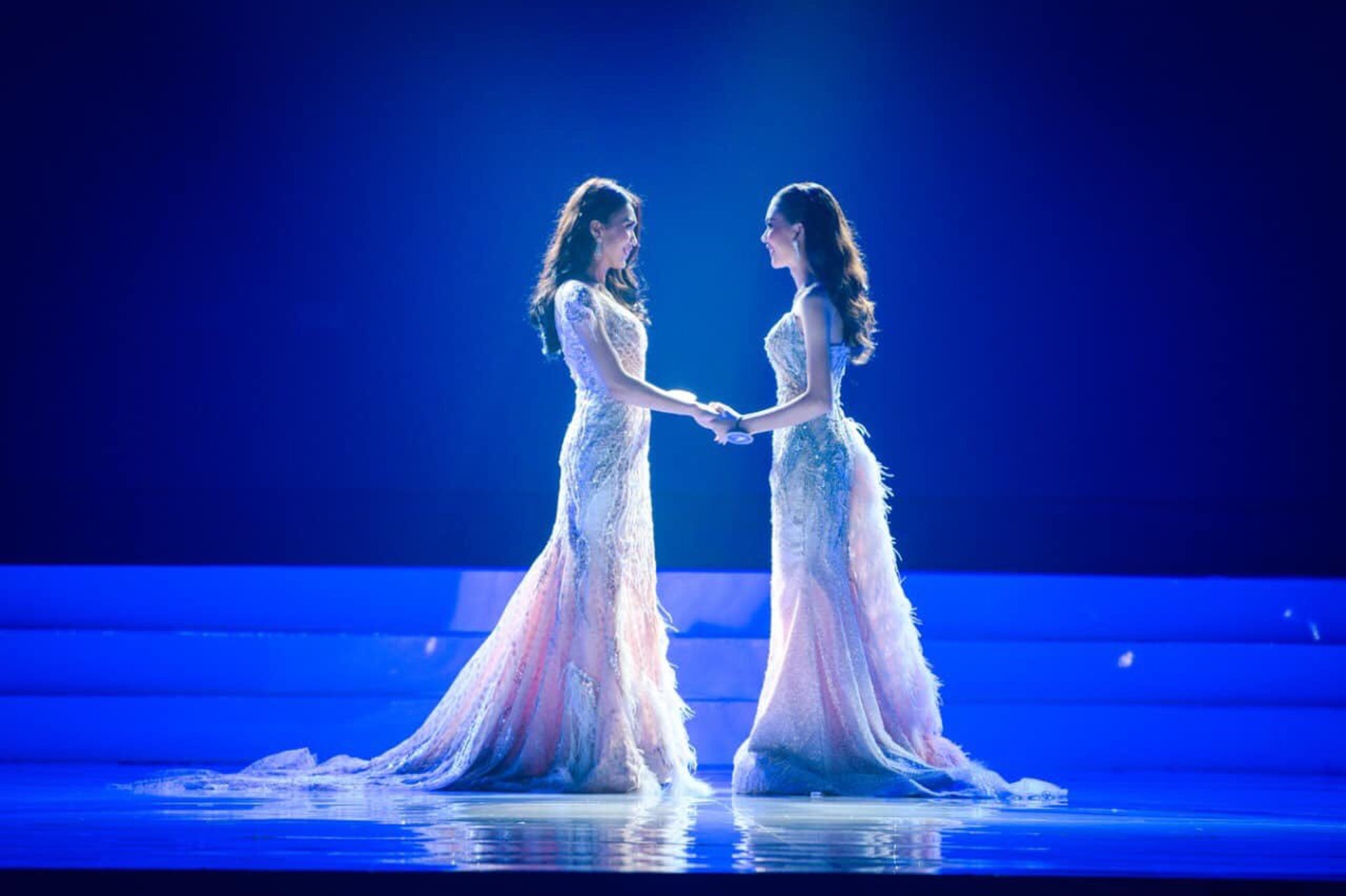 a boat sitting on top of a river under a cloudy sky
