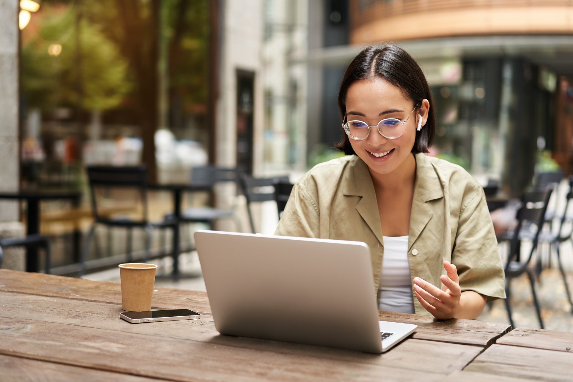 woman in white shirt using macbook