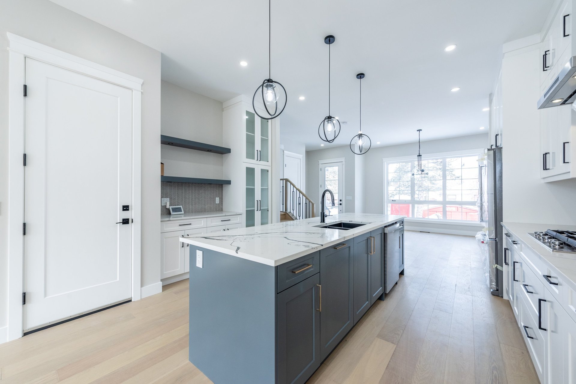 person holding pencil near laptop computer