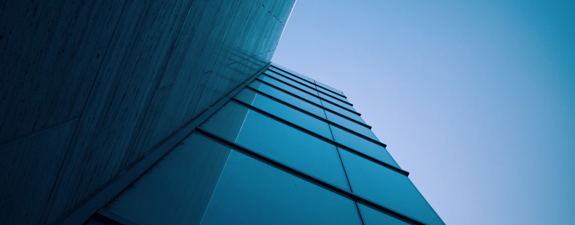 an abstract photo of a curved building with a blue sky in the background
