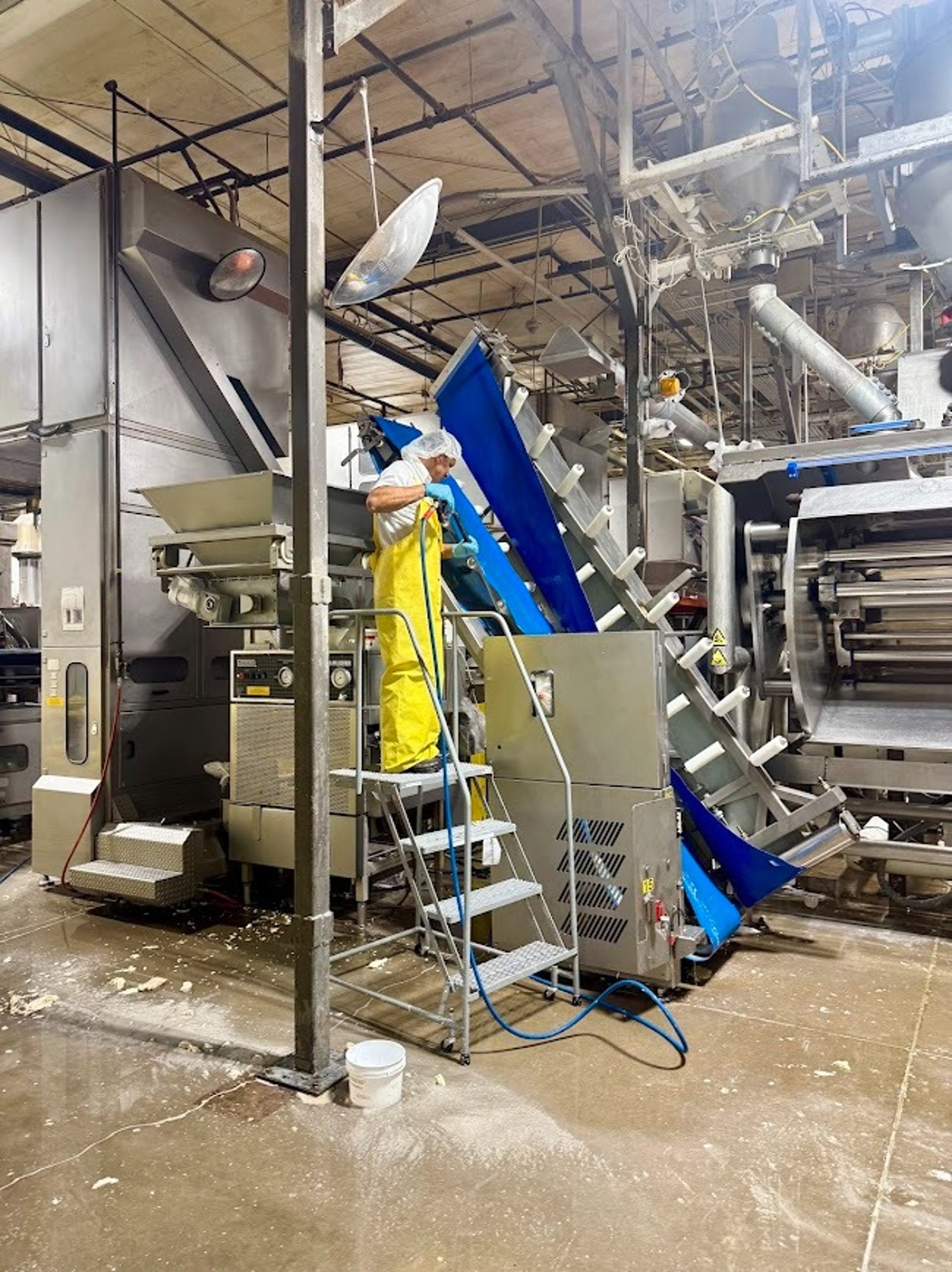 PRECISION CLEANING SERVICES SPECIALIST SANITIZES A HOPPER PER GMP REQUIREMENTS