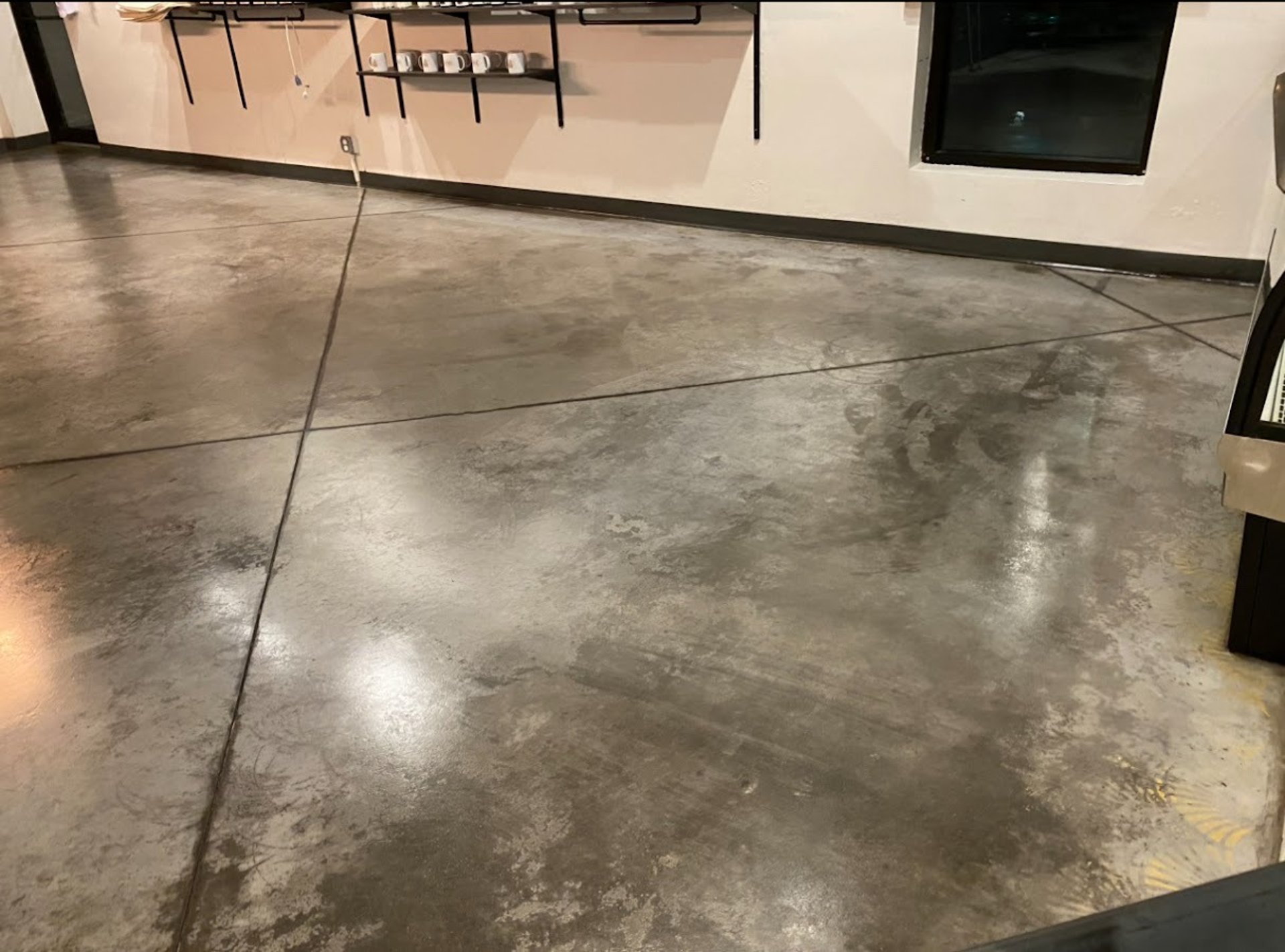 CONCRETE STAINING PROFESSIONAL WORKING IN A BUSINESS
