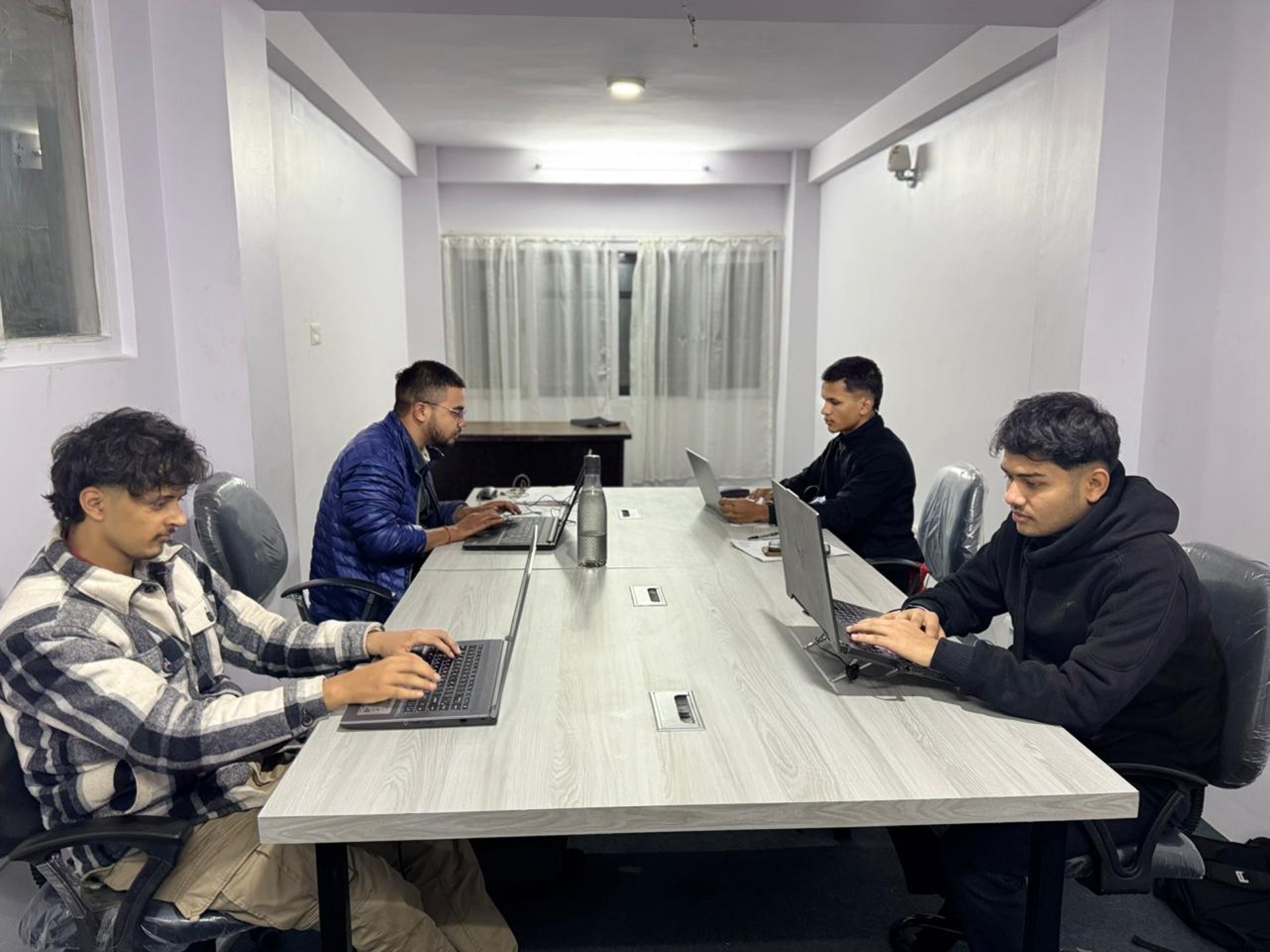 oval brown wooden conference table and chairs inside conference room