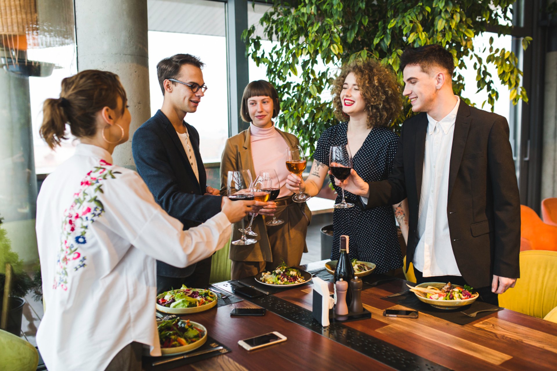 people raising wine glass in selective focus photography