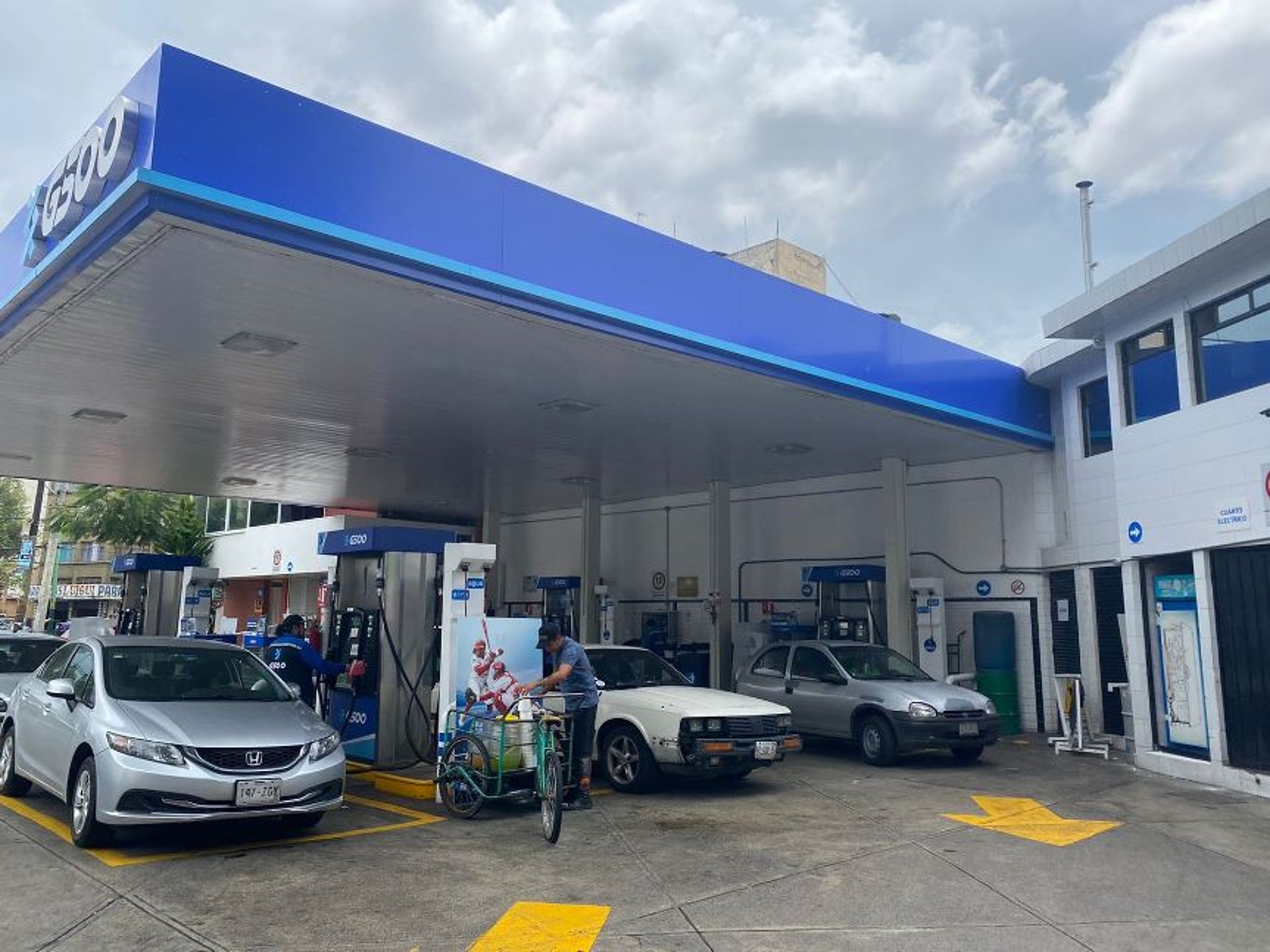 woman wearing yellow long-sleeved dress under white clouds and blue sky during daytime