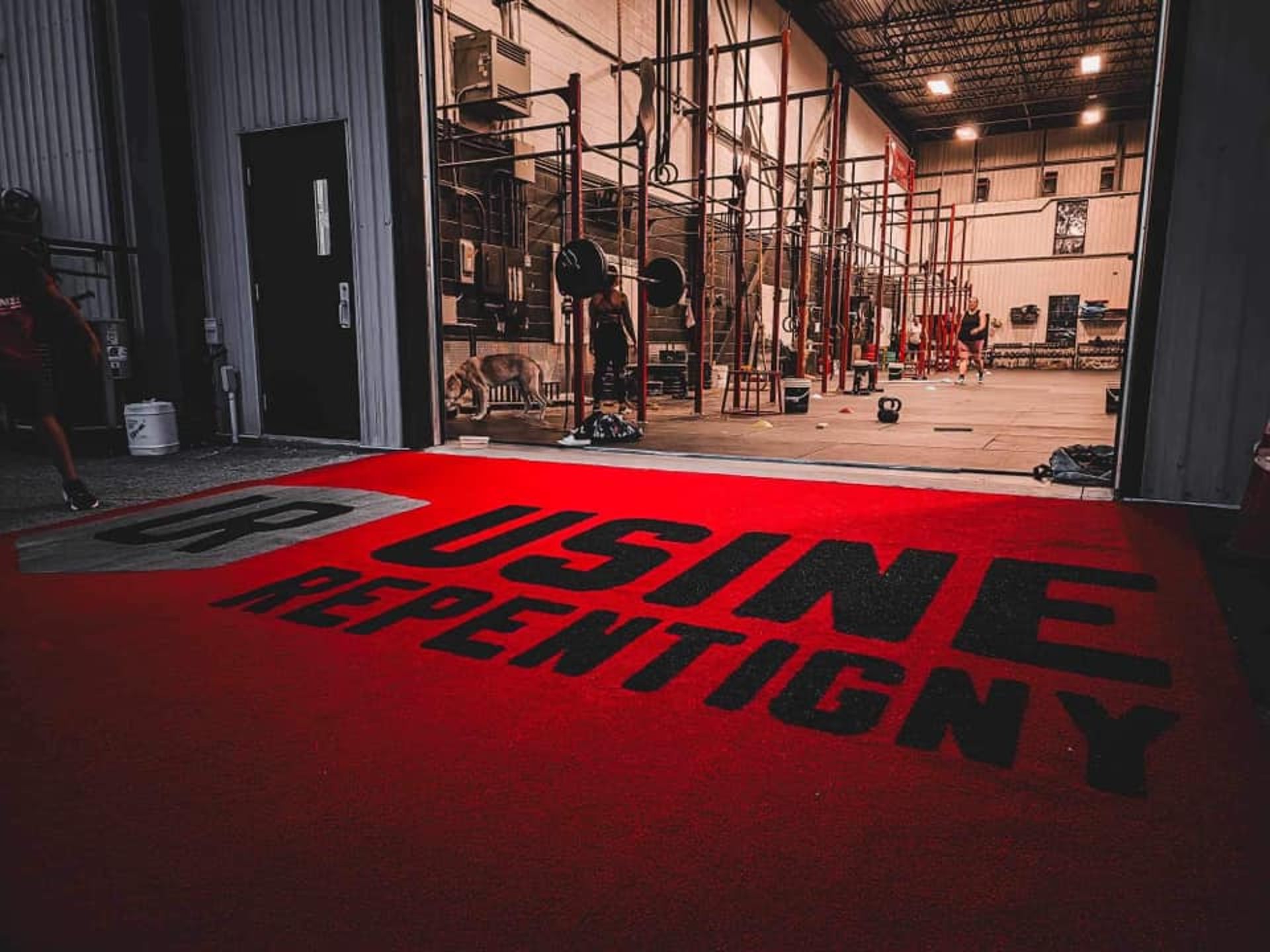 person locking gym plates on barbell