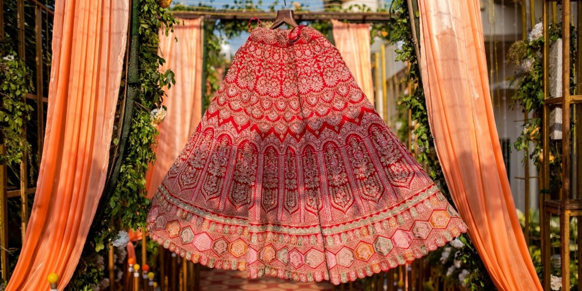 woman in pink floral dress standing near brown wooden chair