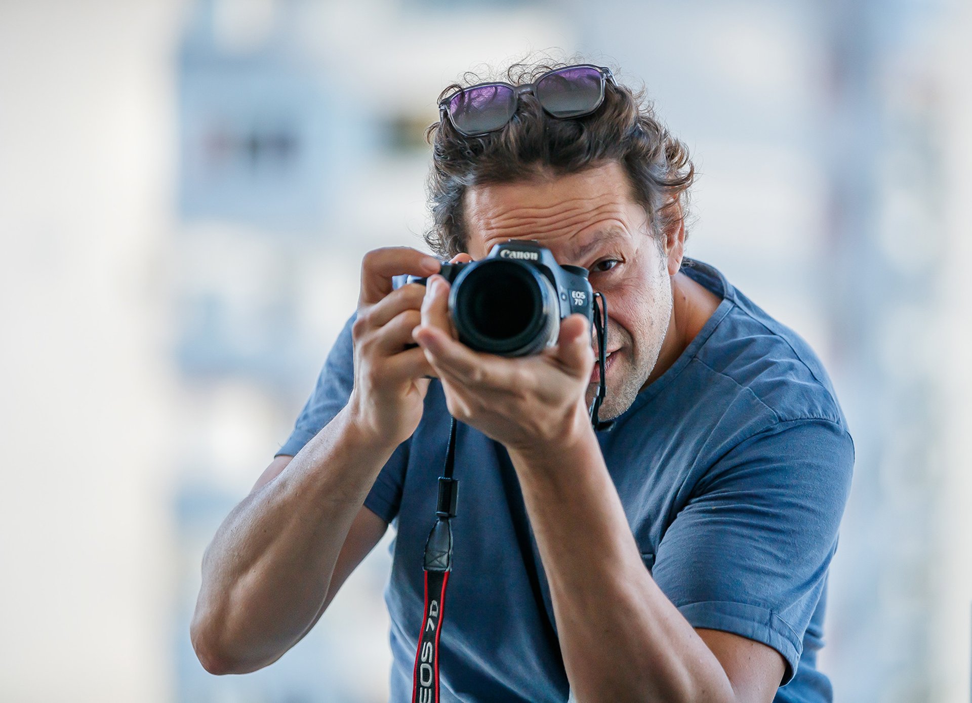 selective focus photography of person taking photo using DSLR camera