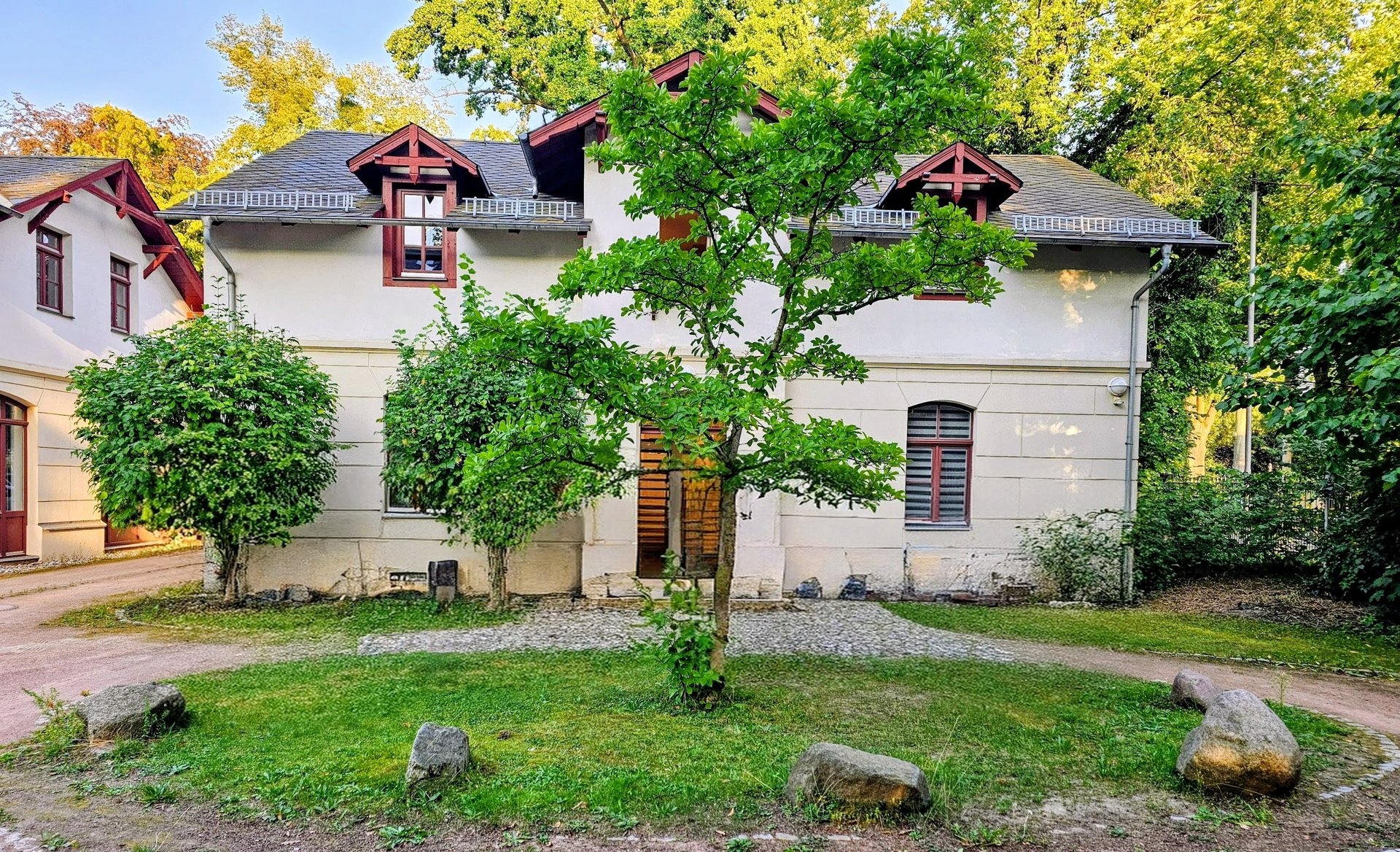 white and brown concrete building near body of water during daytime