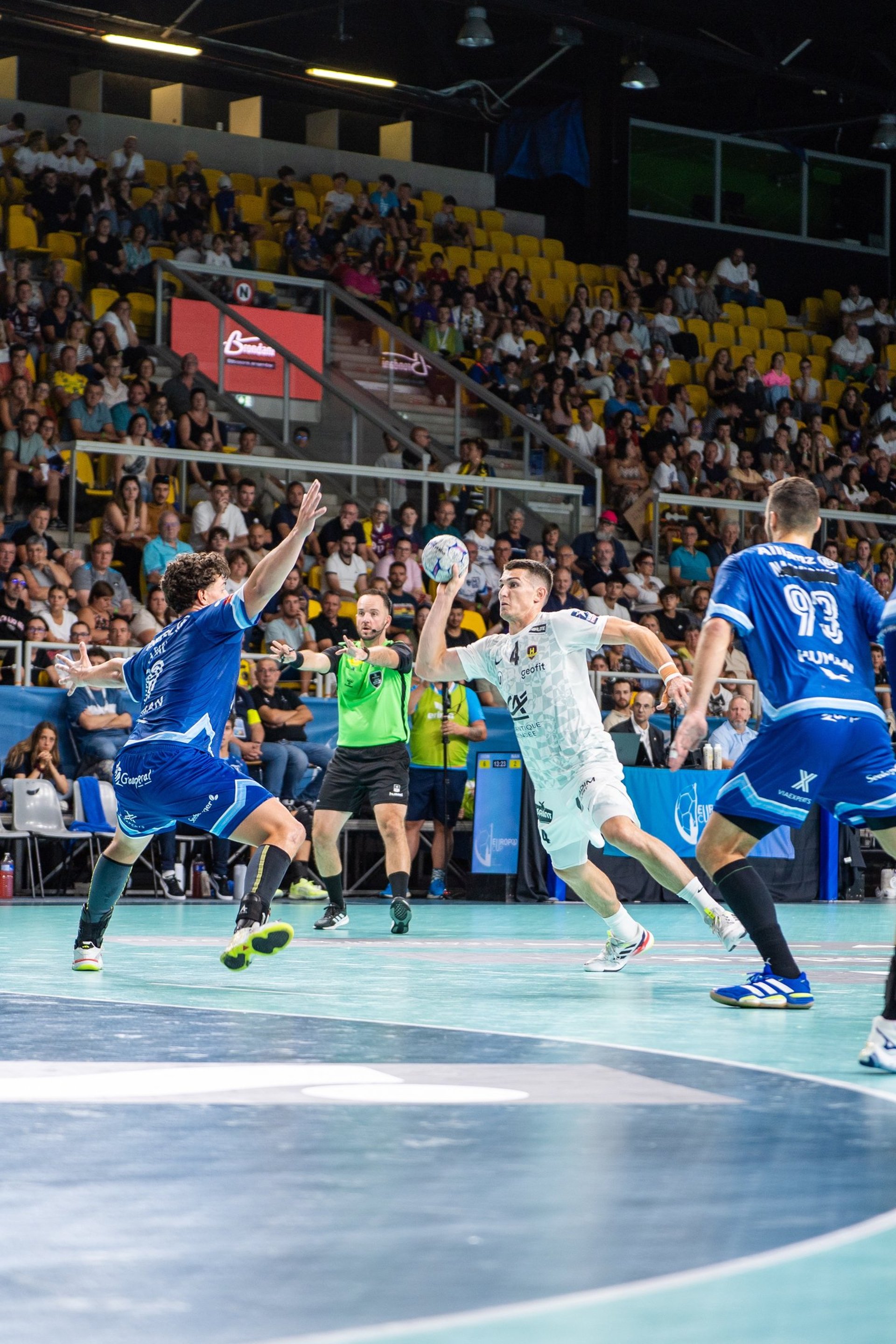 an abstract photo of a curved building with a blue sky in the background