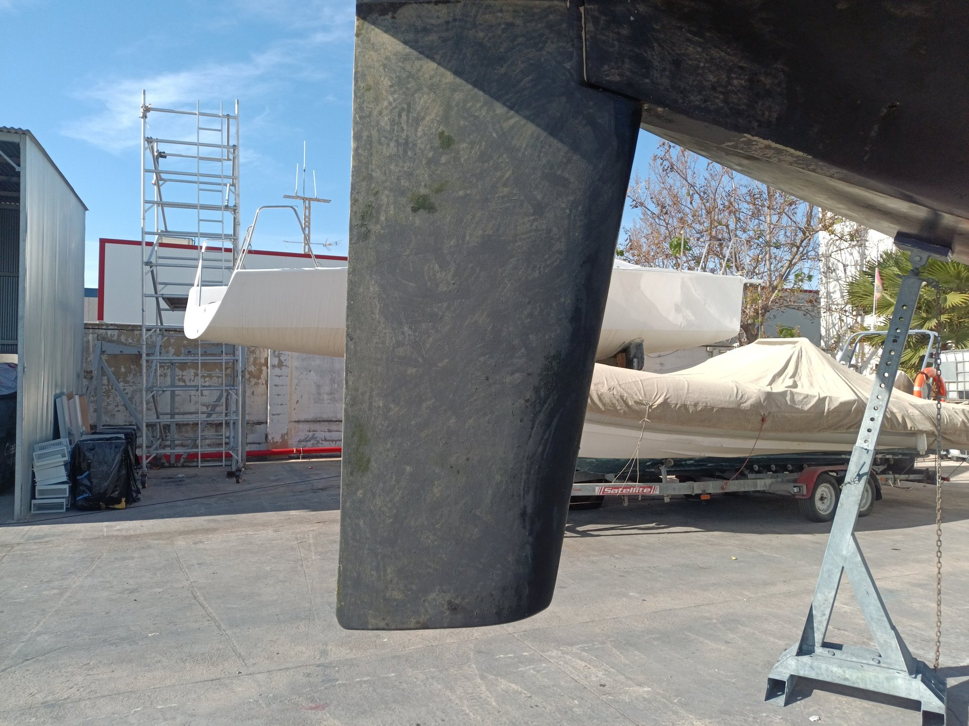 three sail boats on water during daytime