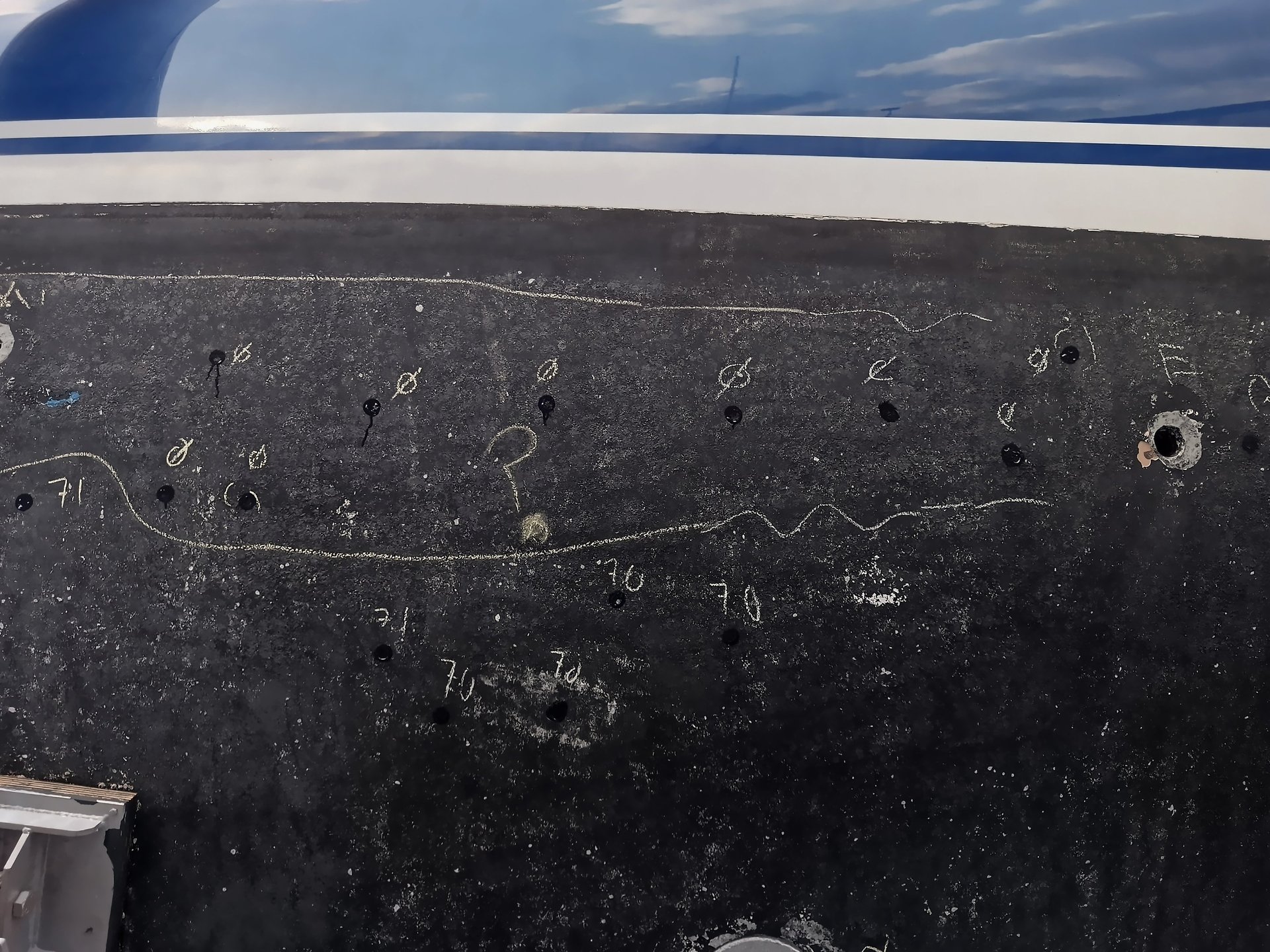 an abstract photo of a curved building with a blue sky in the background