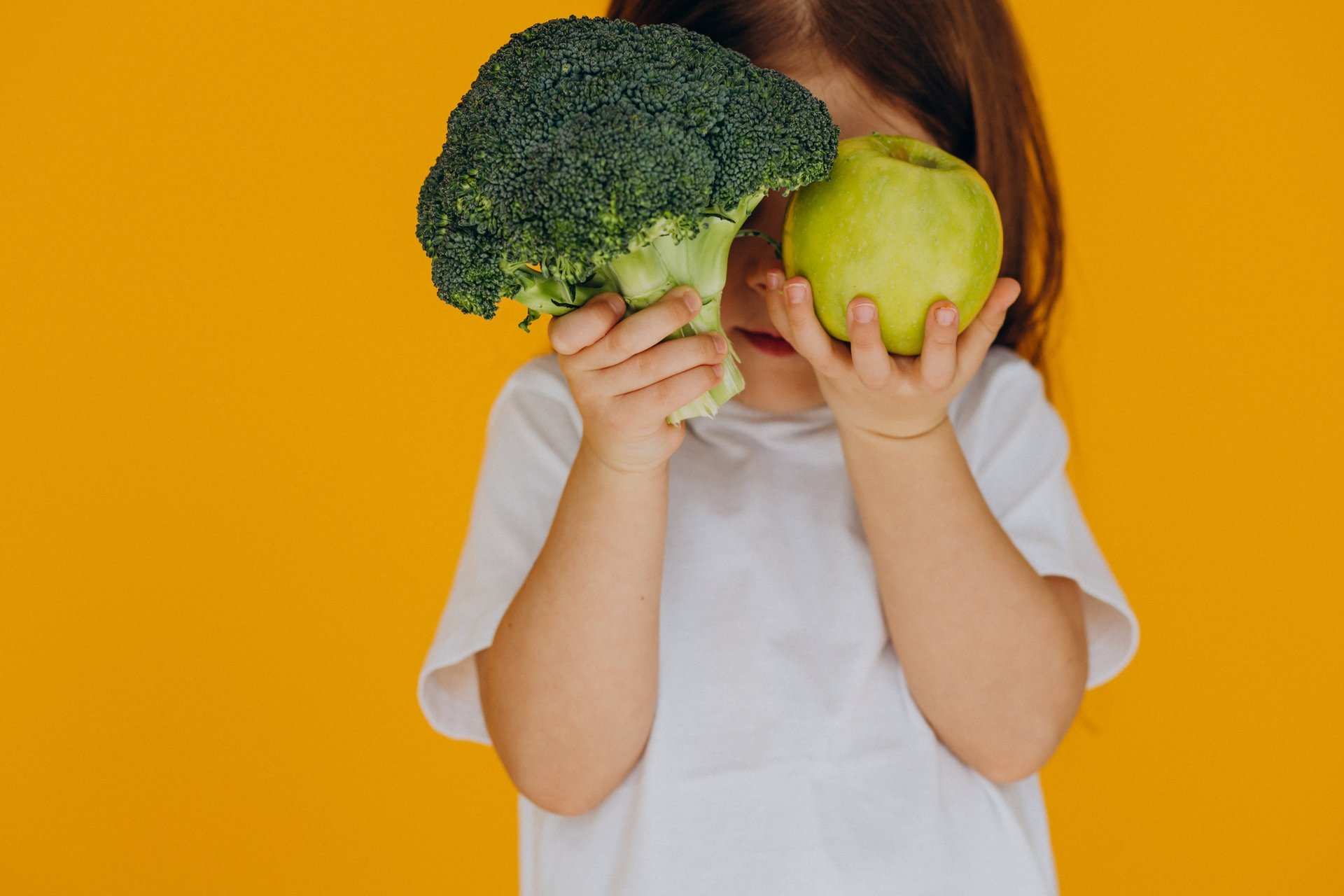 woman wearing yellow long-sleeved dress under white clouds and blue sky during daytime