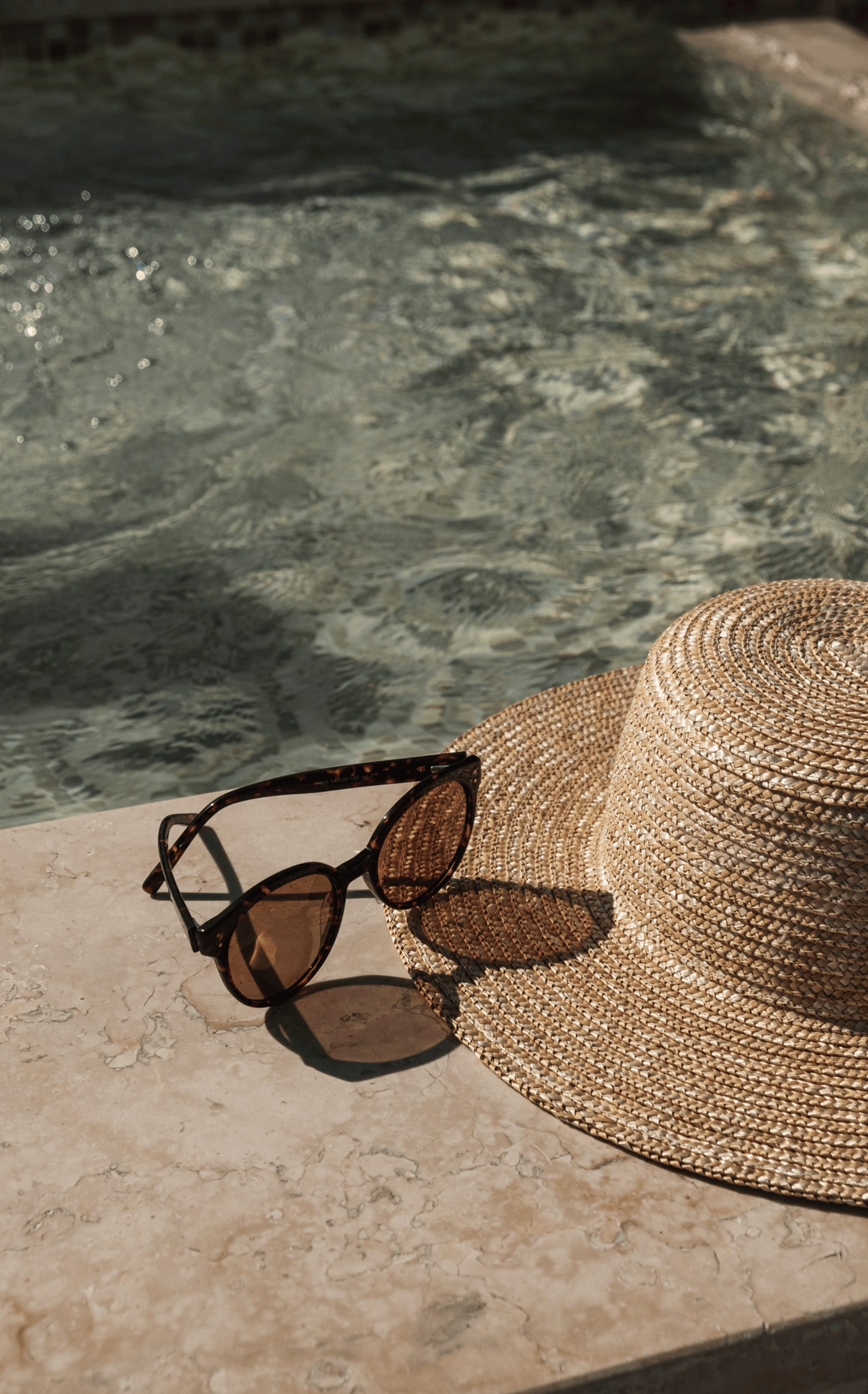 two gray sunbathing loungers beside pool