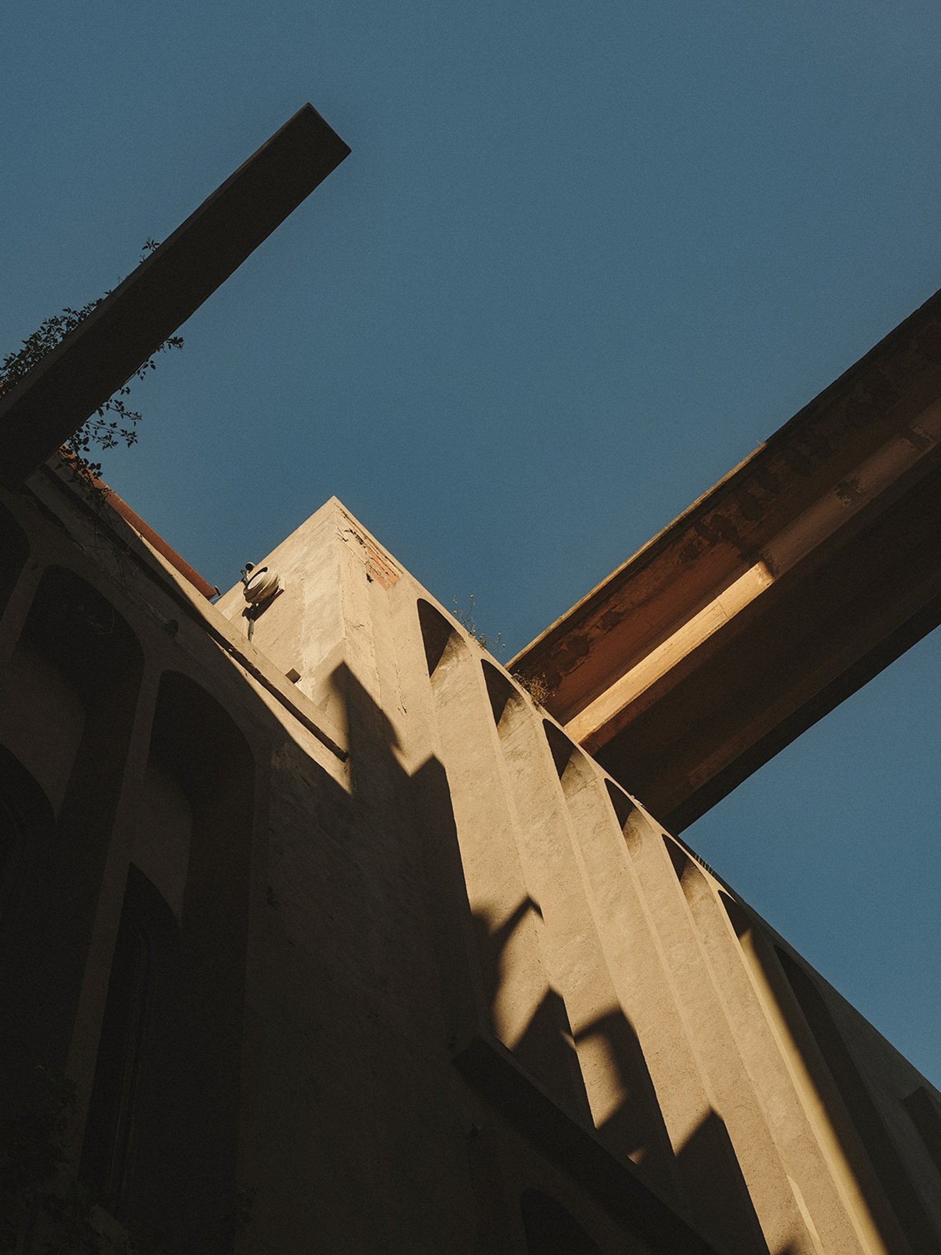 a man working on a scaffold at sunset