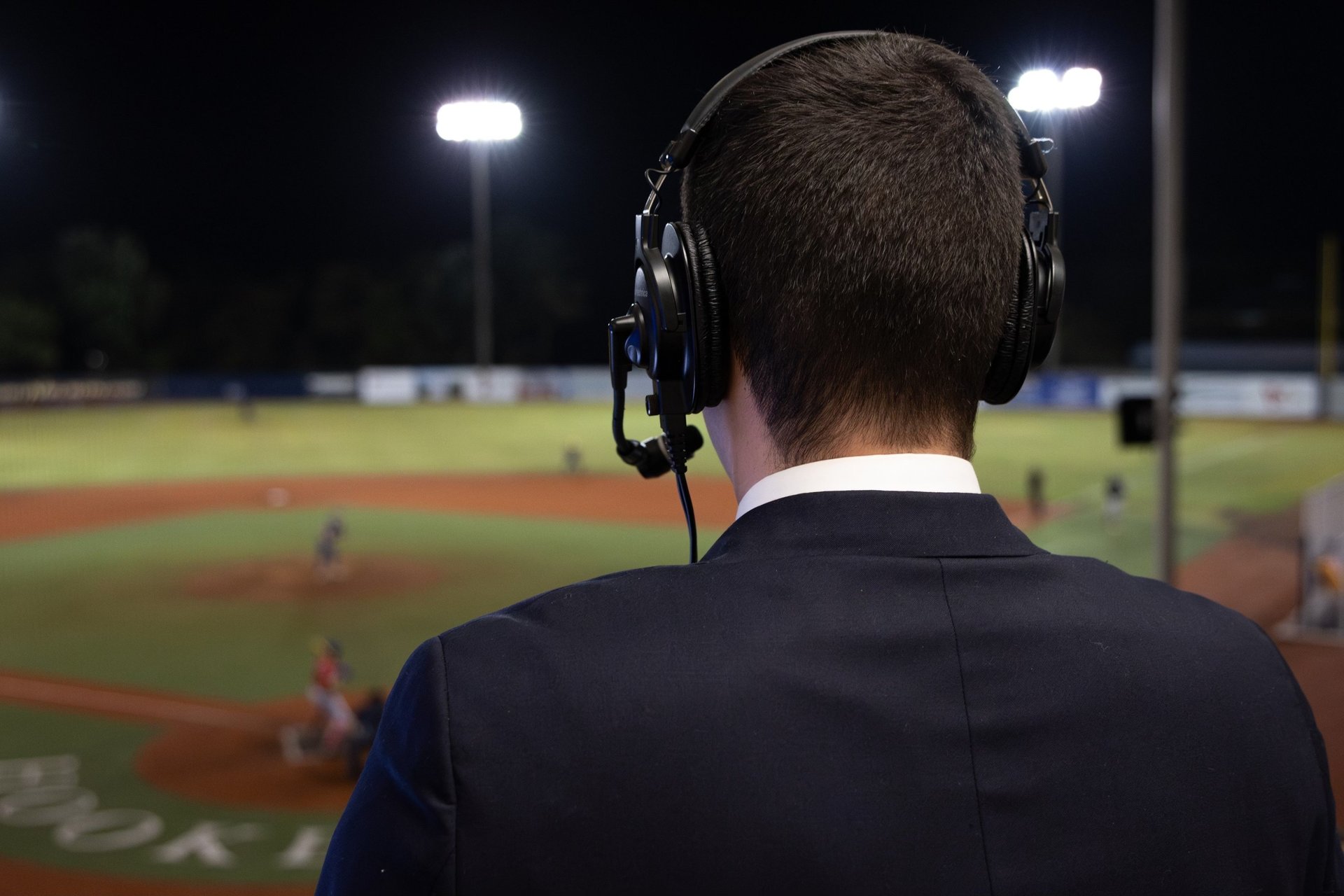 Broadcaster wearing headset with sunset in the background