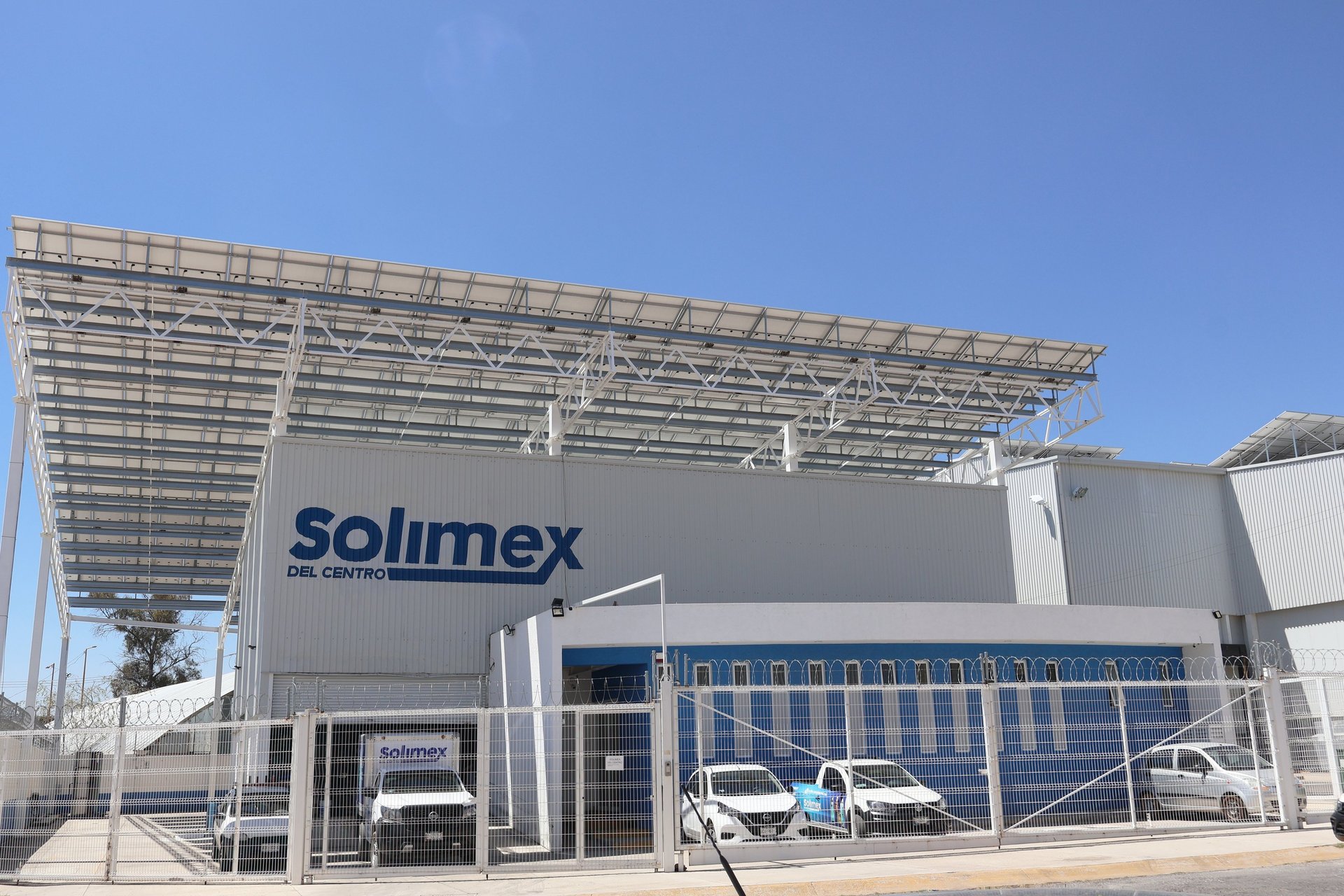 an abstract photo of a curved building with a blue sky in the background