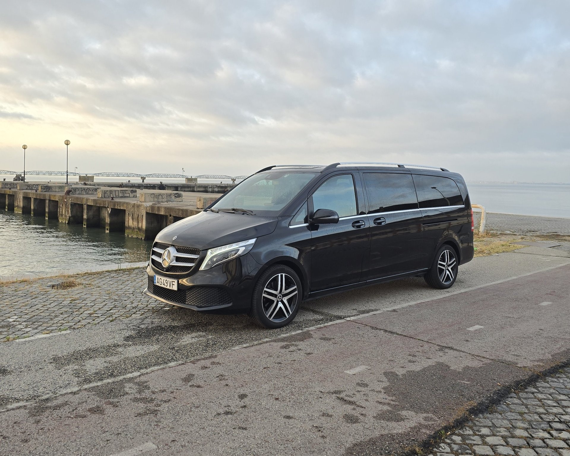 man sitting on chair wearing gray crew-neck long-sleeved shirt using Apple Magic Keyboard