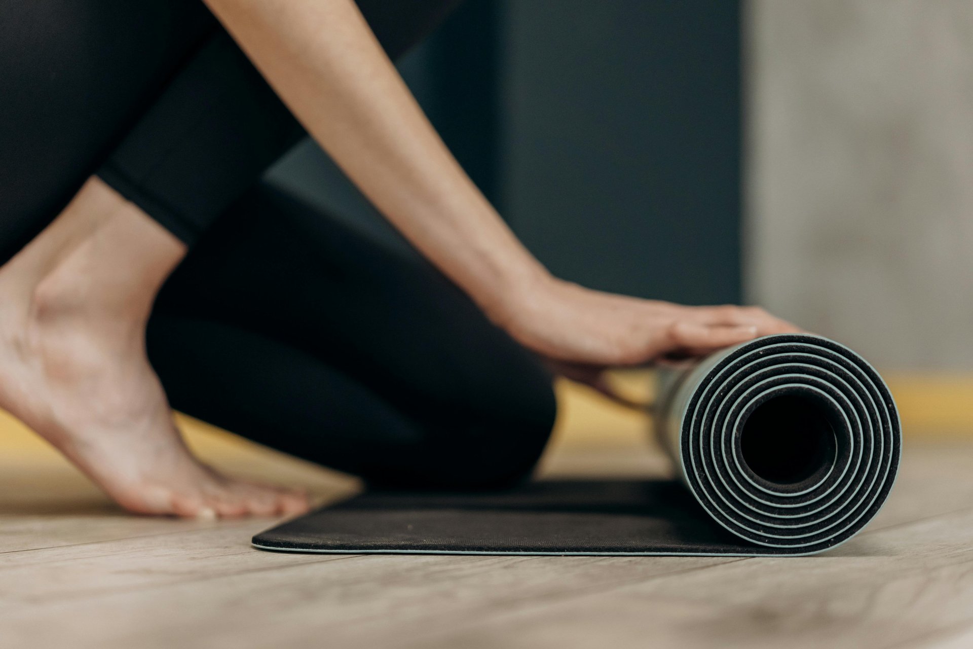 Woman meditating cross-legged on the floor at home.