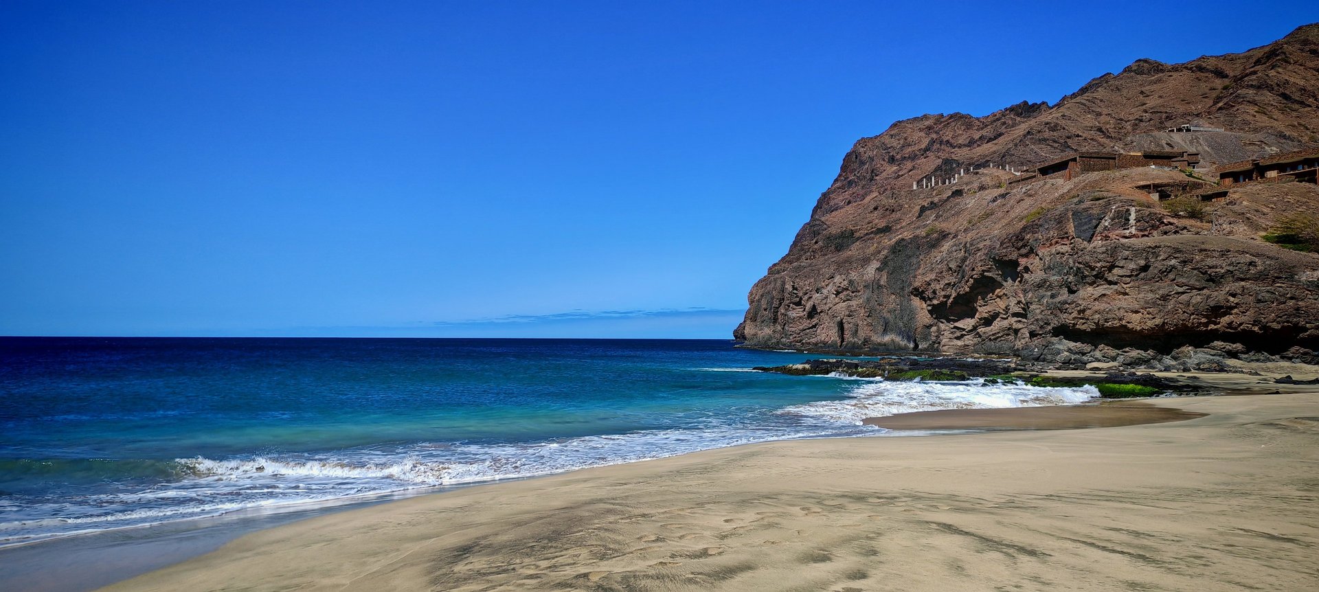 woman wearing yellow long-sleeved dress under white clouds and blue sky during daytime