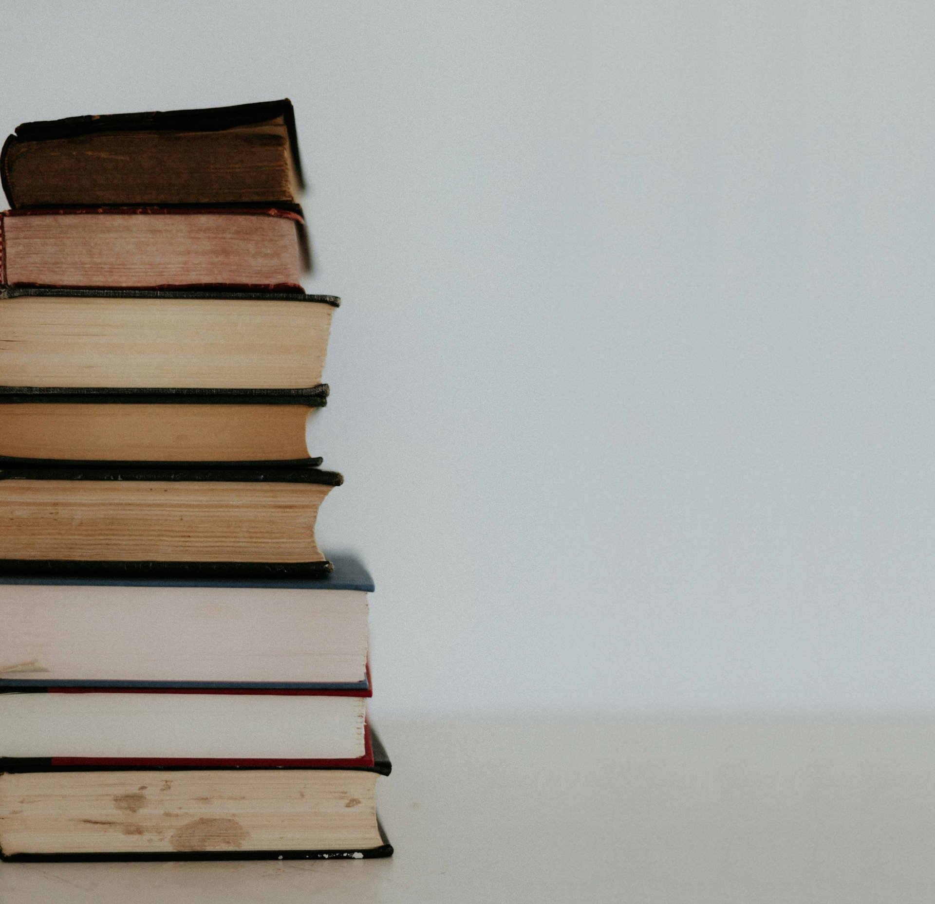 brown and white books on white table