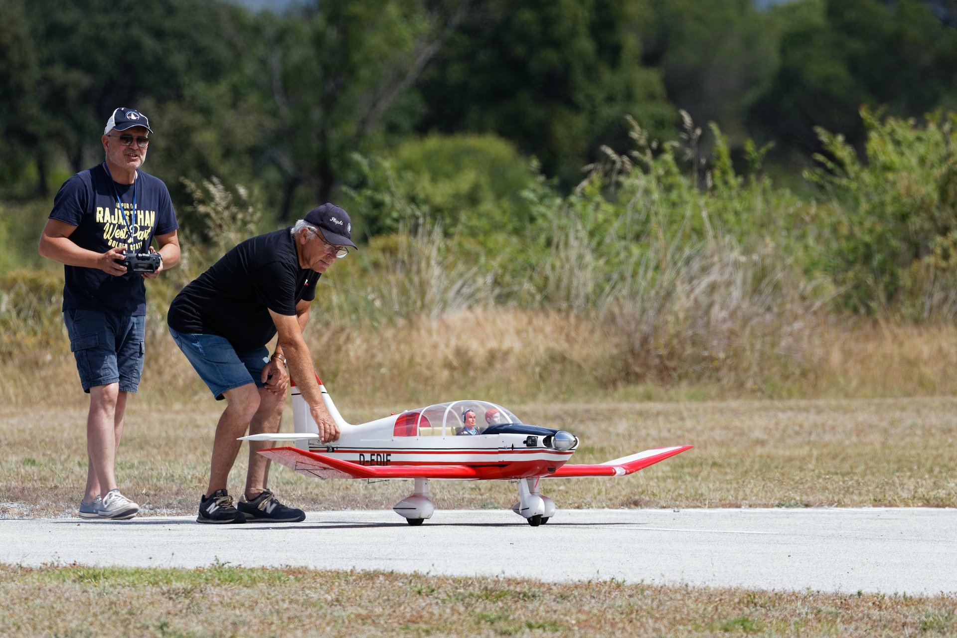 Two men ready to fly an RC airplane.