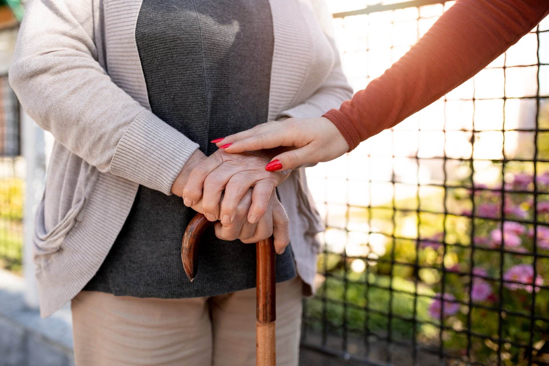 woman standing next to woman riding wheelchair