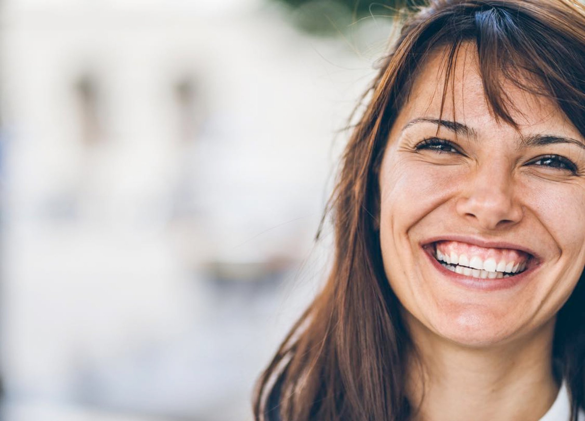 smiling woman wearing red sleeveless dress