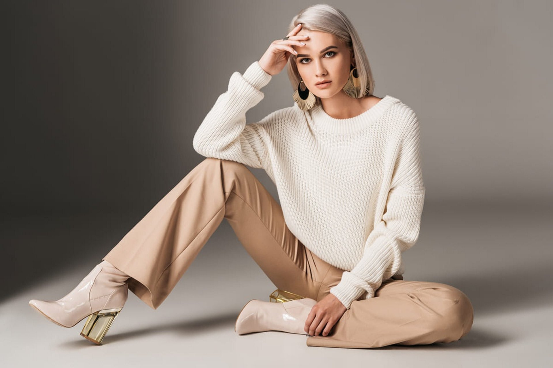 person wearing grey knit sweater