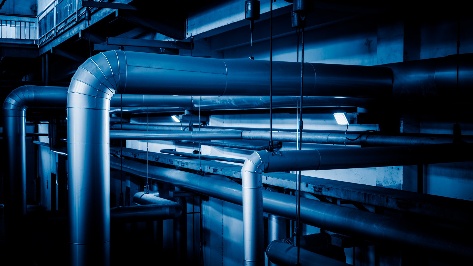 an abstract photo of a curved building with a blue sky in the background