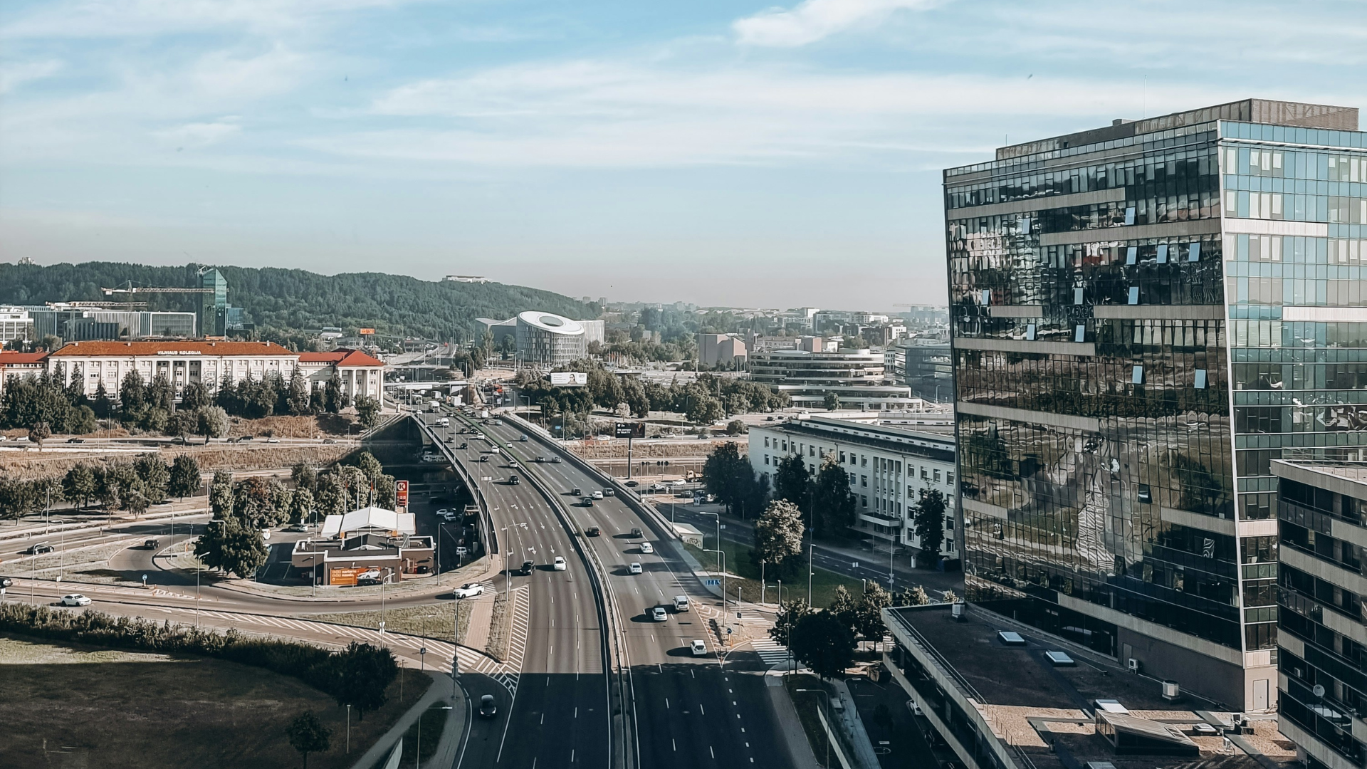 a street with cars and people walking on it