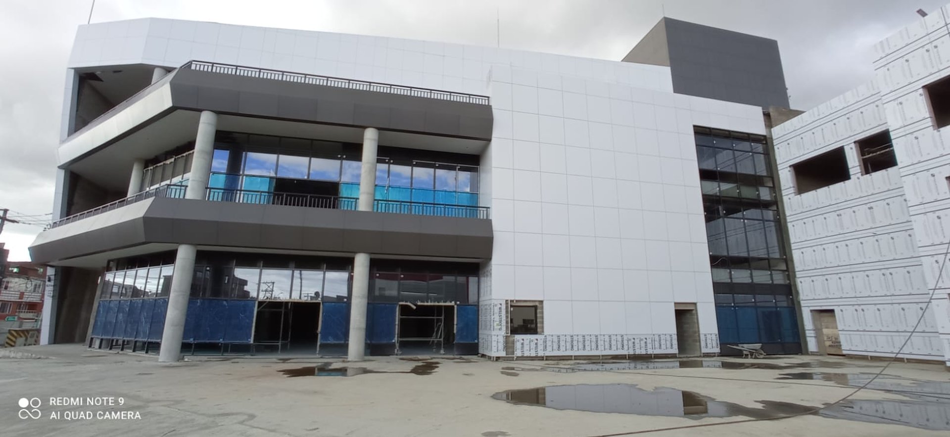 a large glass building with a sky background