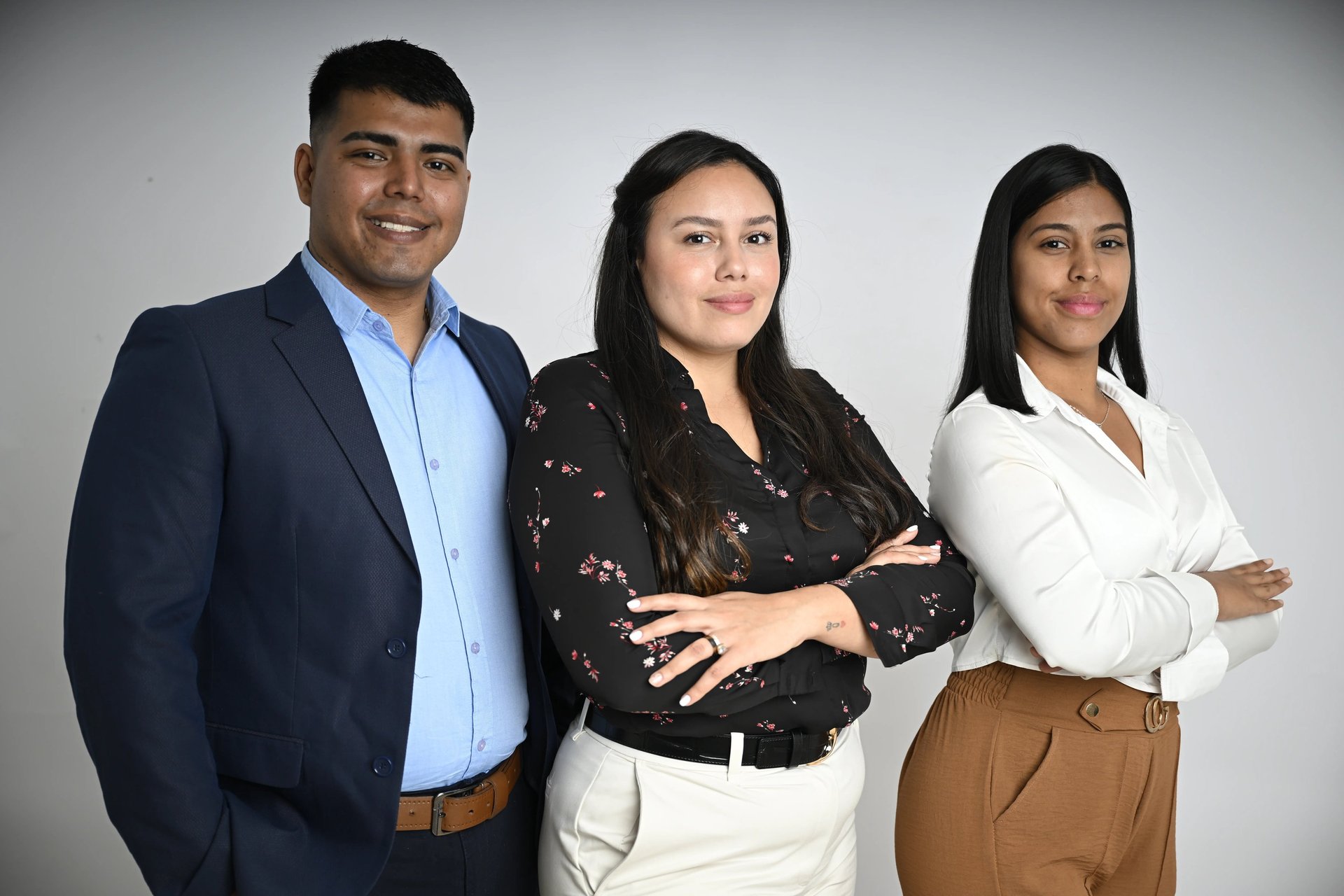 woman signing on white printer paper beside woman about to touch the documents