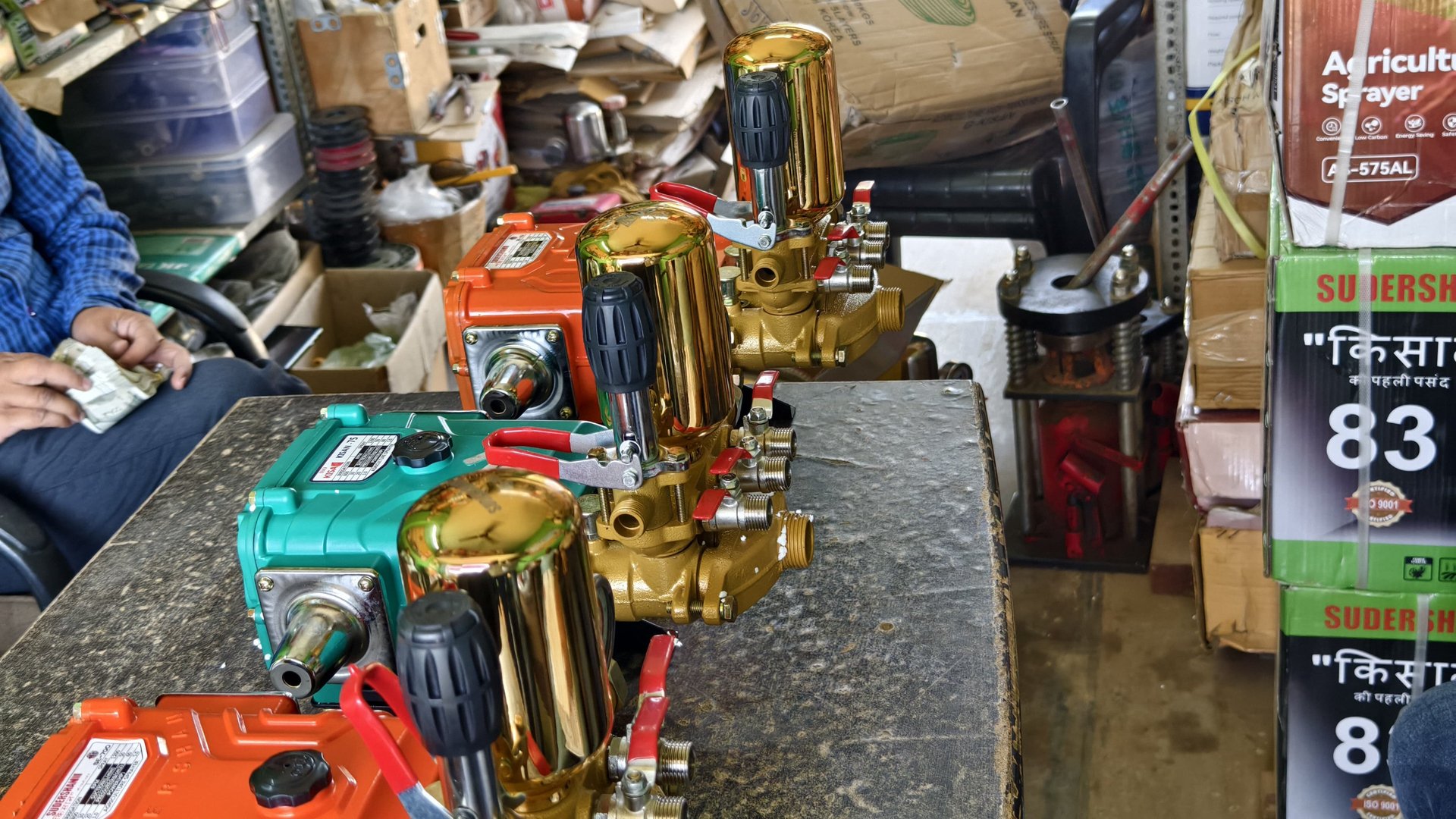 man standing while carrying wicker basket in the middle of rice field surrounded with tall trees