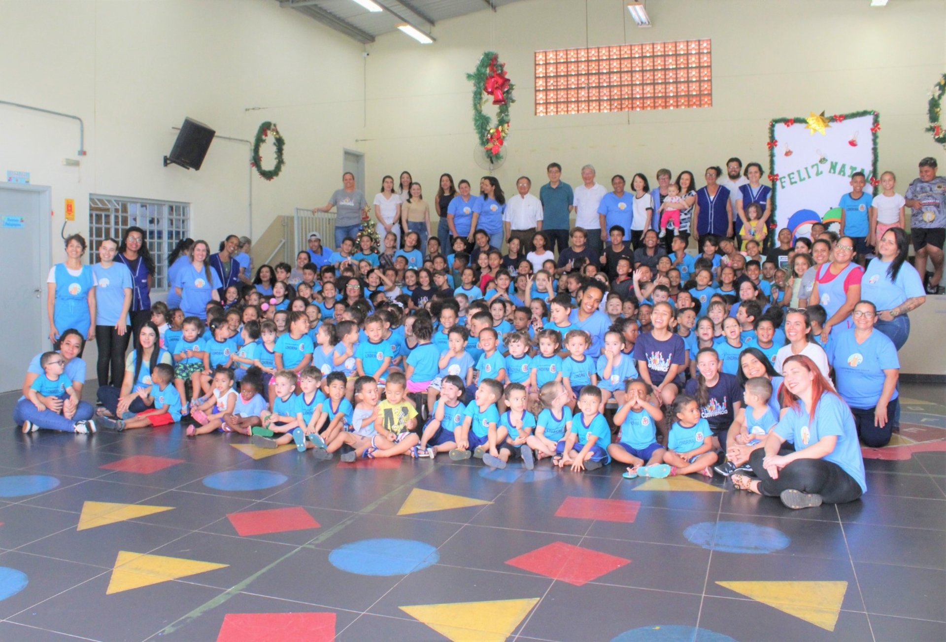 a little boy that is sitting at a table with some crayons