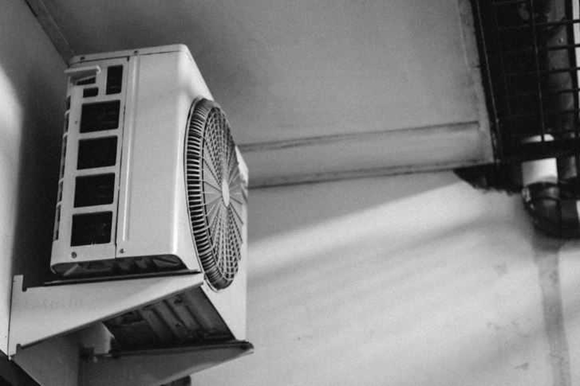a black and white photo of a wall mounted air conditioner