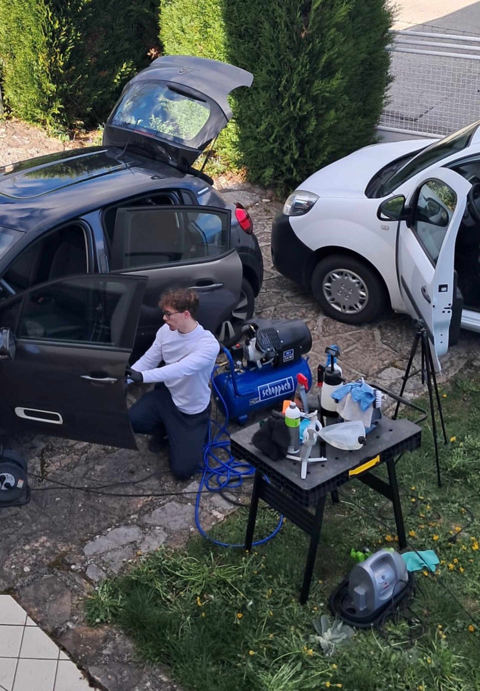 a man with a glove on his hand is changing the tire of a car