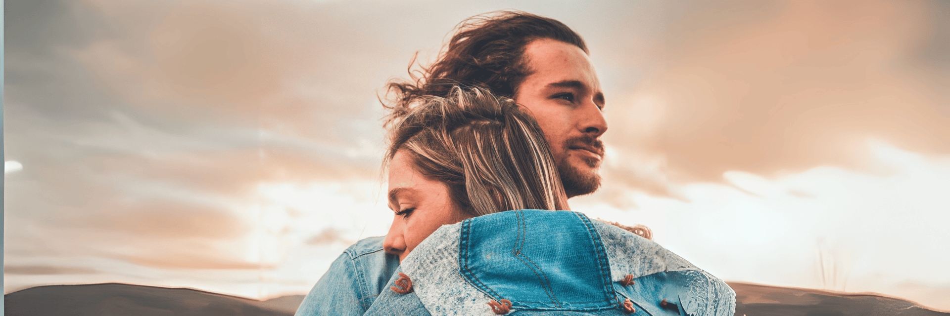 selective focus photography of couple hugging