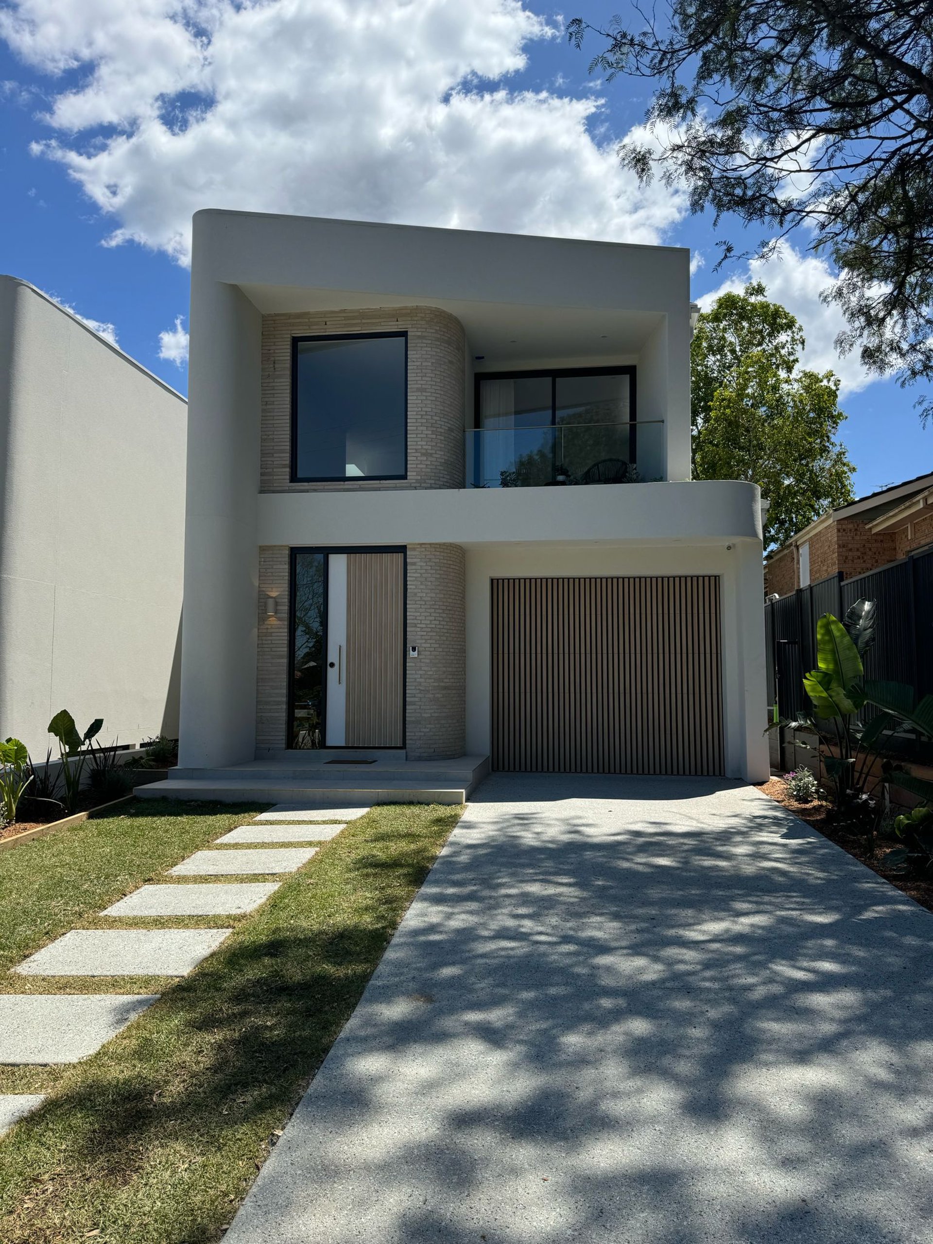 an abstract photo of a curved building with a blue sky in the background