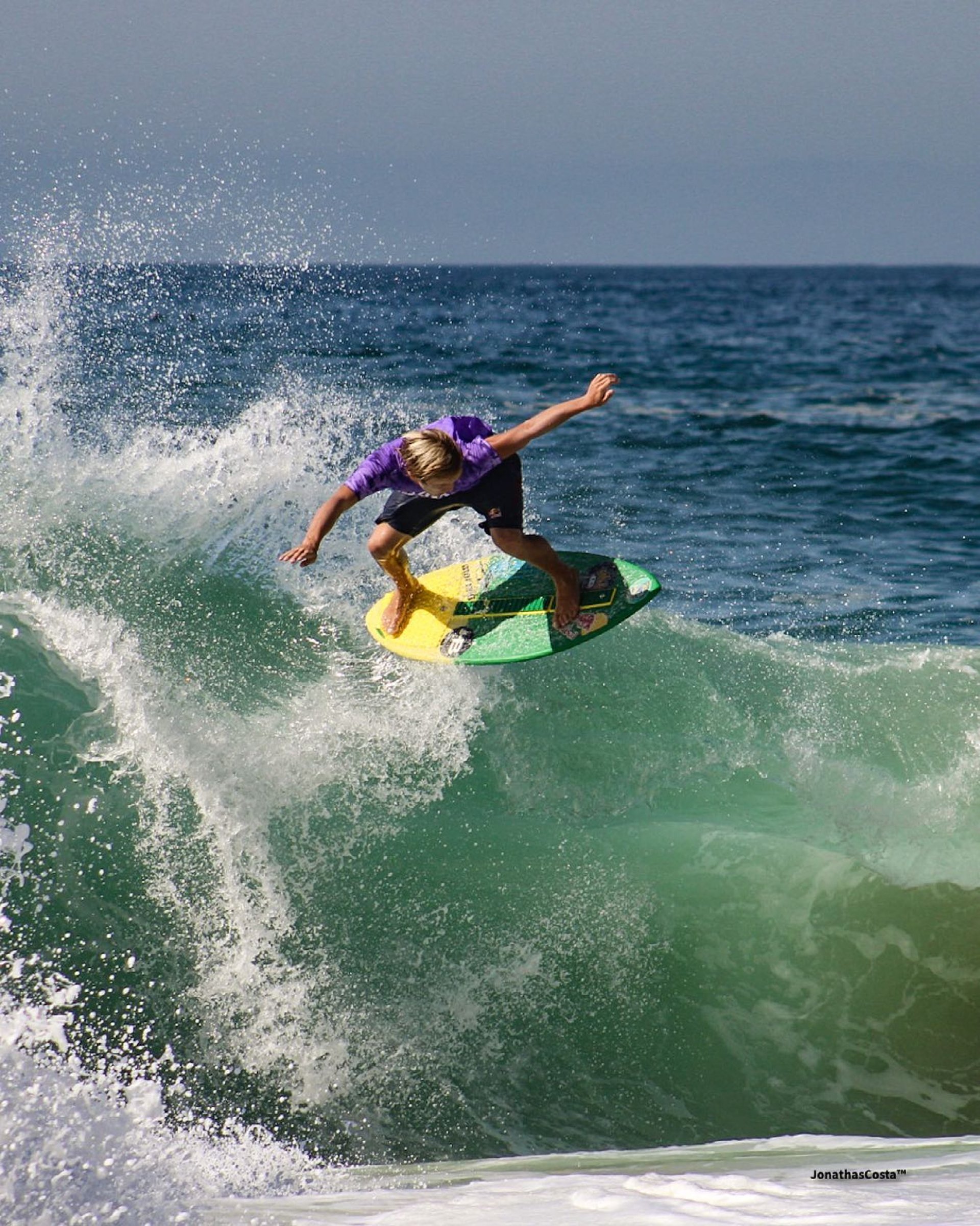 an abstract photo of a curved building with a blue sky in the background