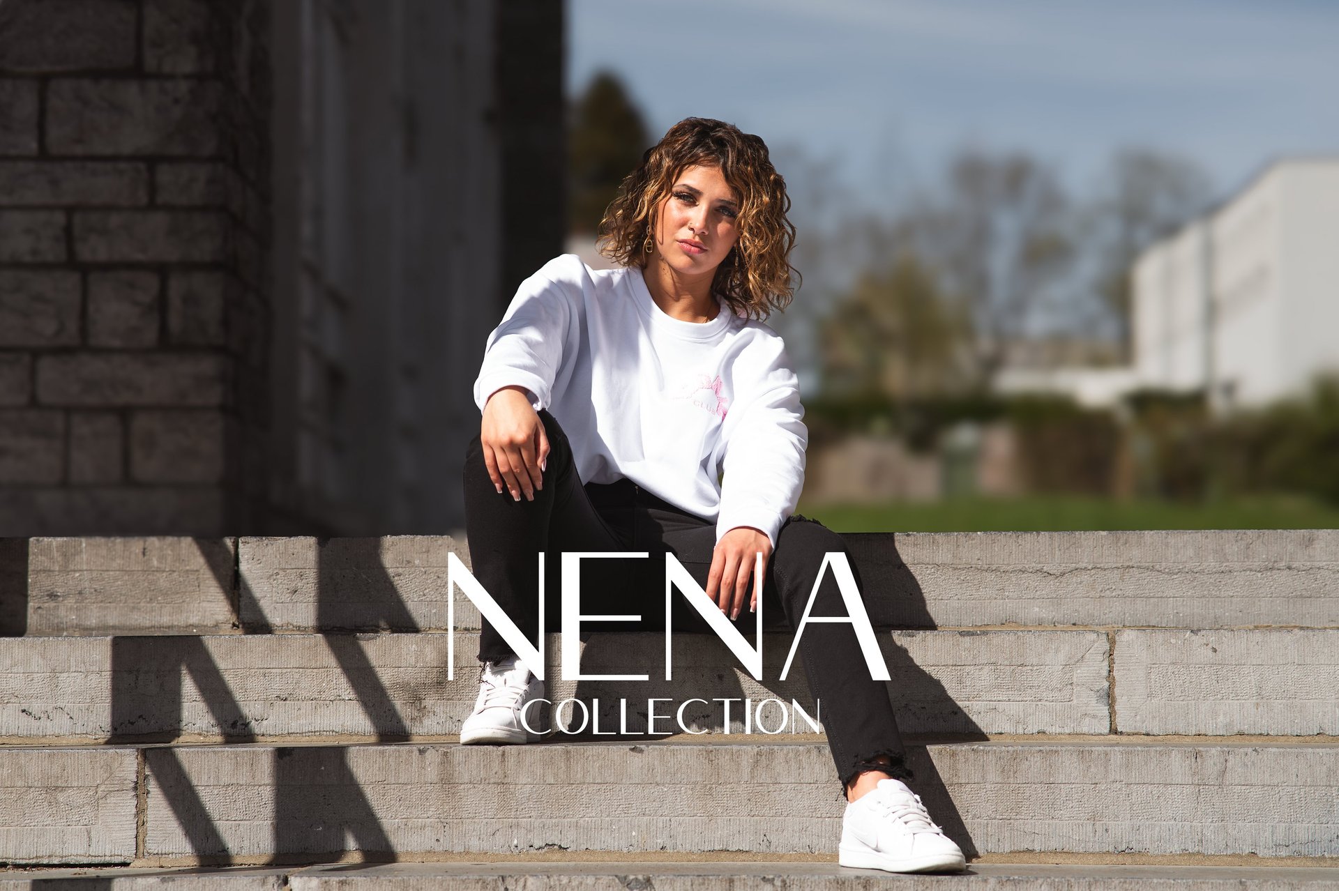 woman with brown hair wearing white and black floral hijab