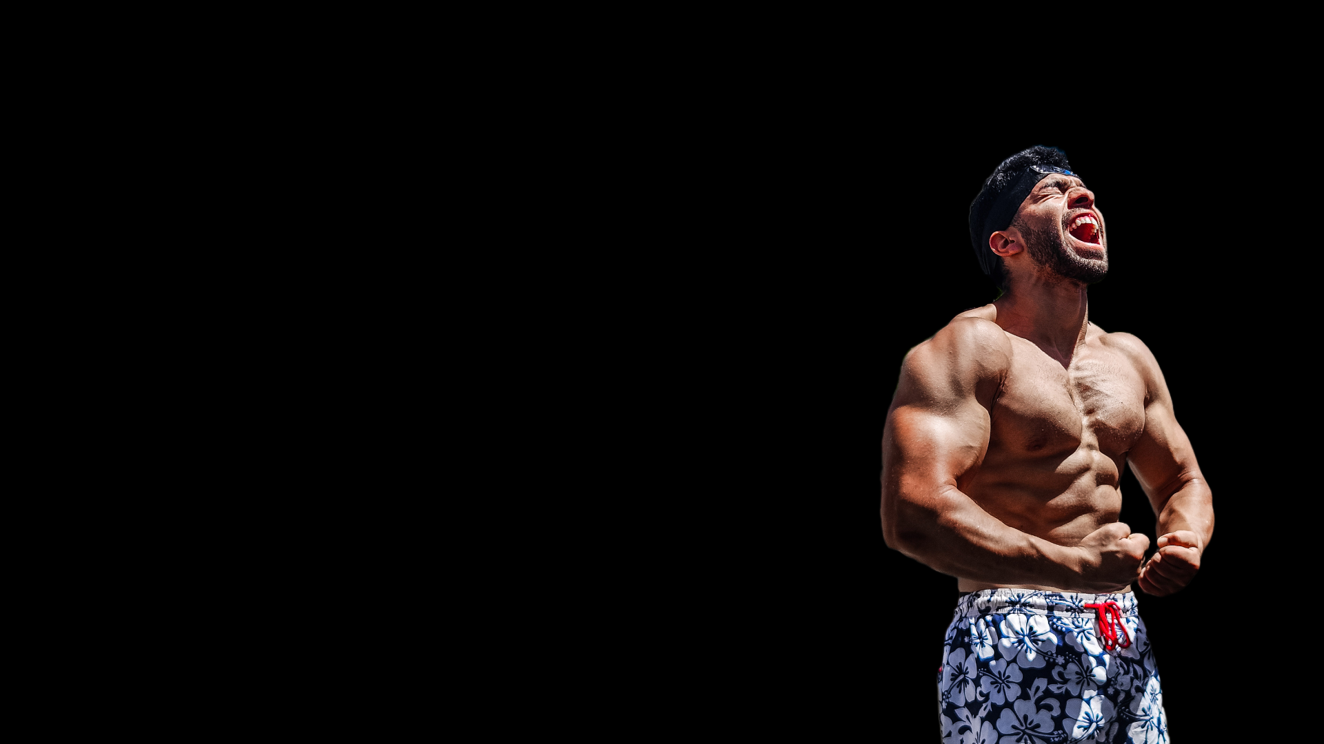 topless man in black shorts sitting on black and silver barbell