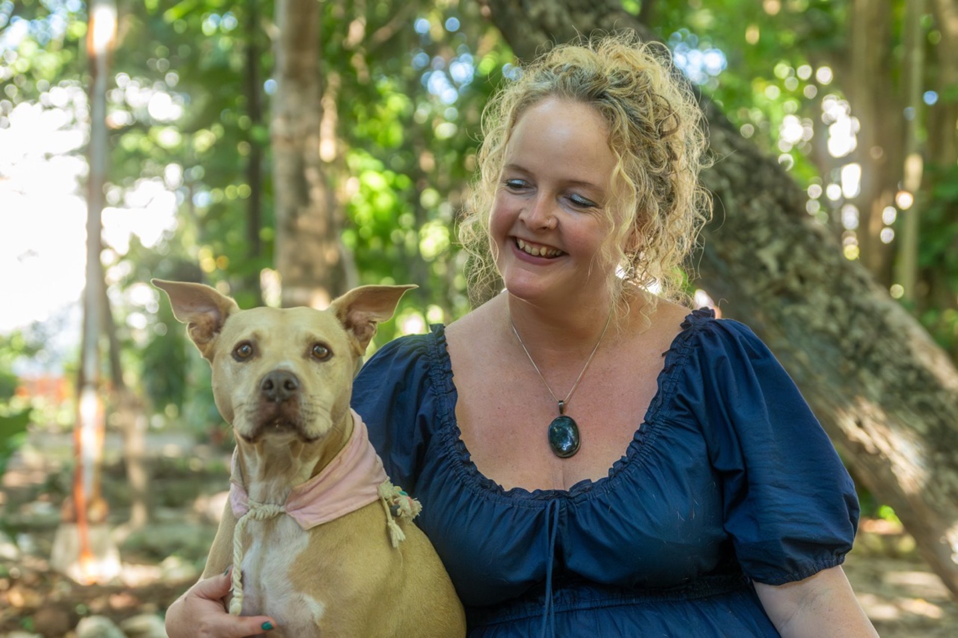 Sunni Dawson smiling with a dog companion during animal communication session