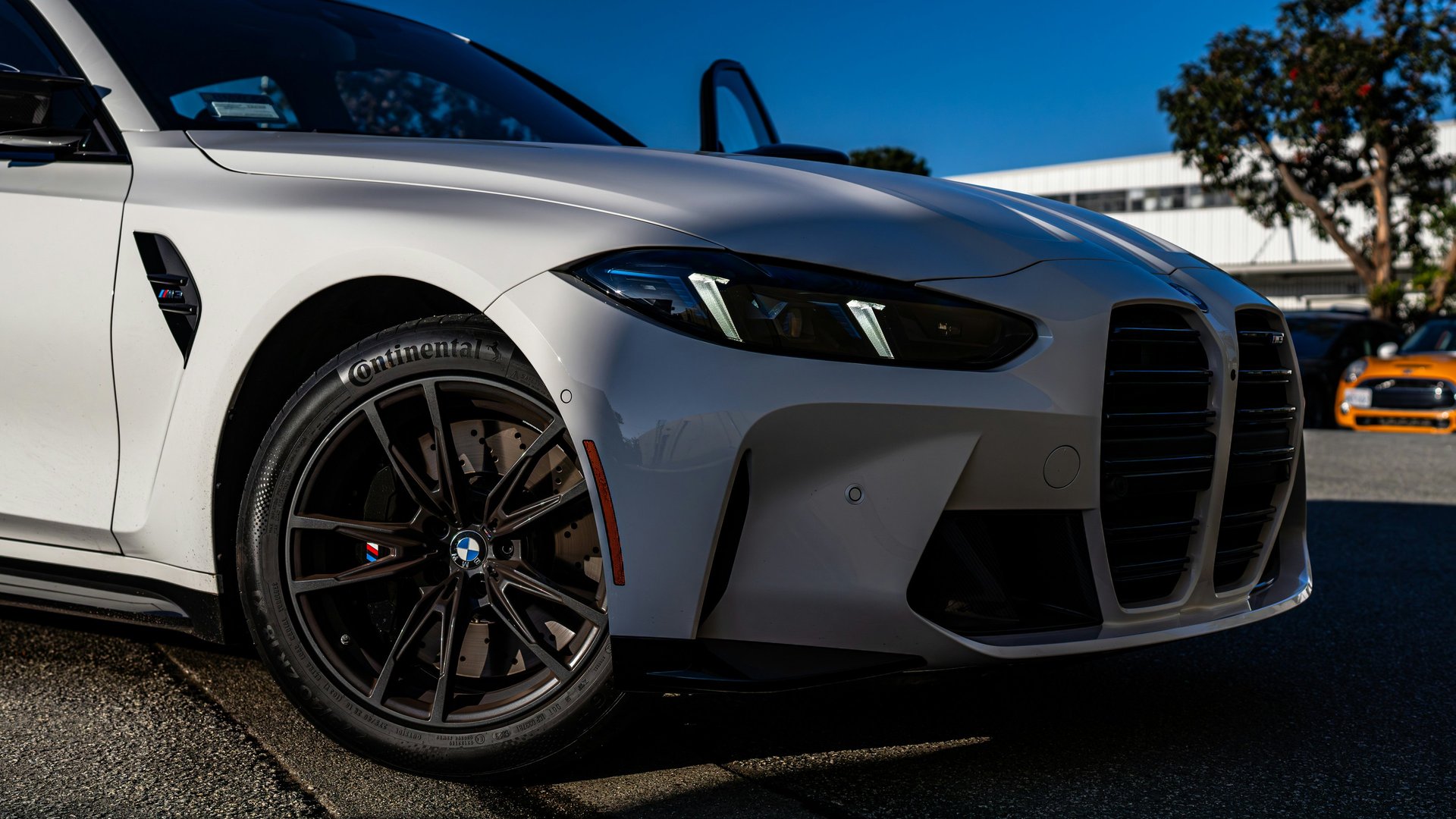 an abstract photo of a curved building with a blue sky in the background